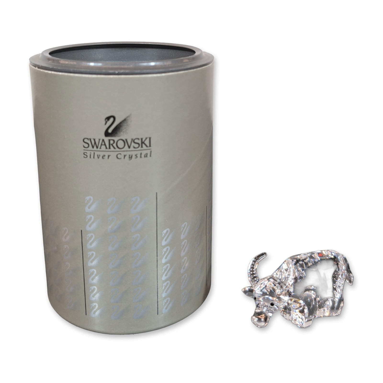 Swarovski Crystal Chinese Zodiac Ox Figurine: The ox features a faceted clear crystal body, distinctively curved horns, and small black bead eyes. The piece bears an etched Swarovski swan logo on the rear flank. Includes the original Swarovski Si