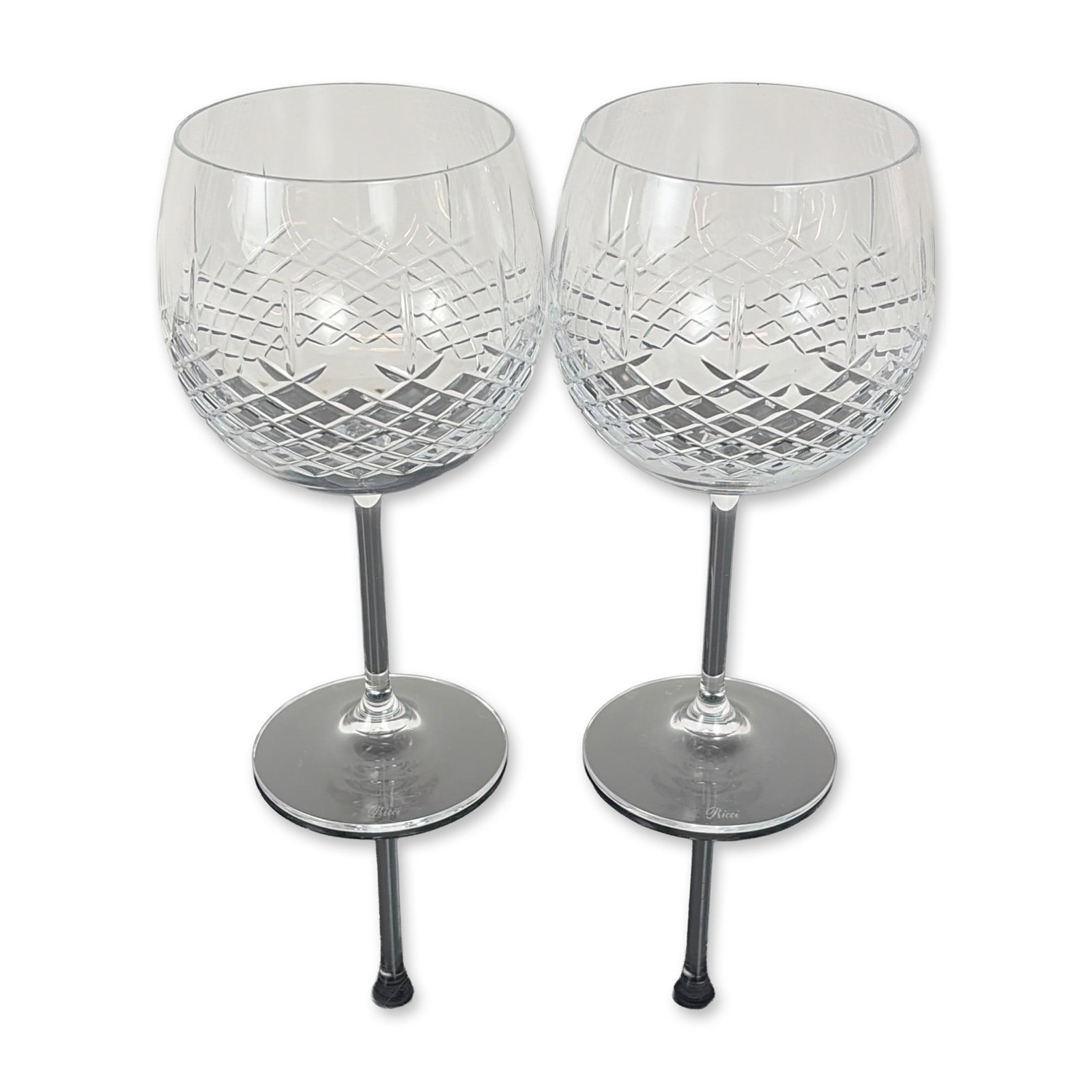 Pair of Ricci Cut Crystal Balloon Wine Glasses: Set of two Ricci Argentieri cut crystal wine glasses. Each glass features a globular bowl decorated with a precision diamond cut pattern to the lower half, transitioning to a clear upper section. The 