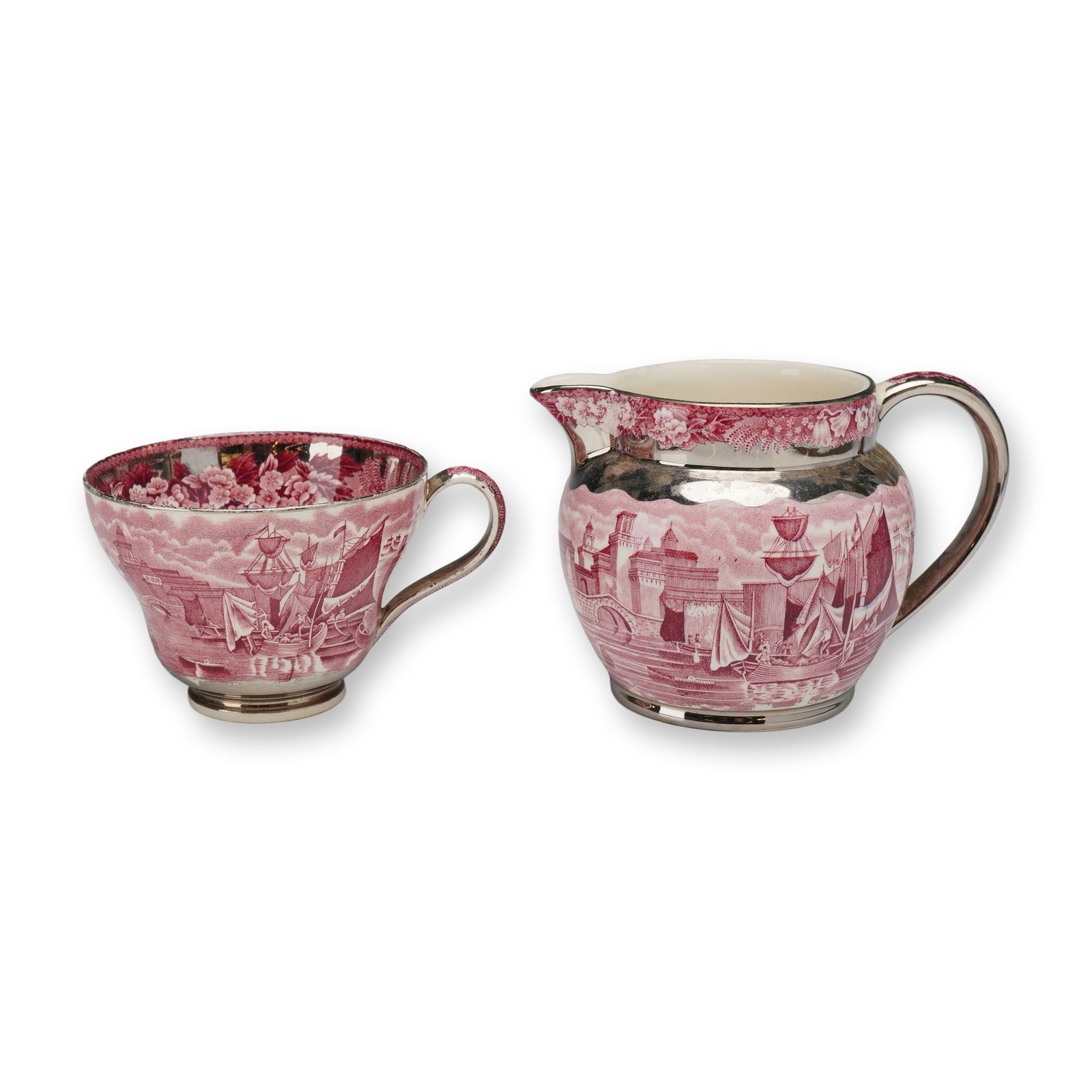 Two-Piece Wedgwood & Barlaston Ferrara Pink Transferware Set, Cup and Creamer Jug: The set is made of earthenware with a pink transfer-printed design. The decoration features a detailed maritime scene with multiple-masted sailing ships in a harbor adjacent to fortified, castle-like 