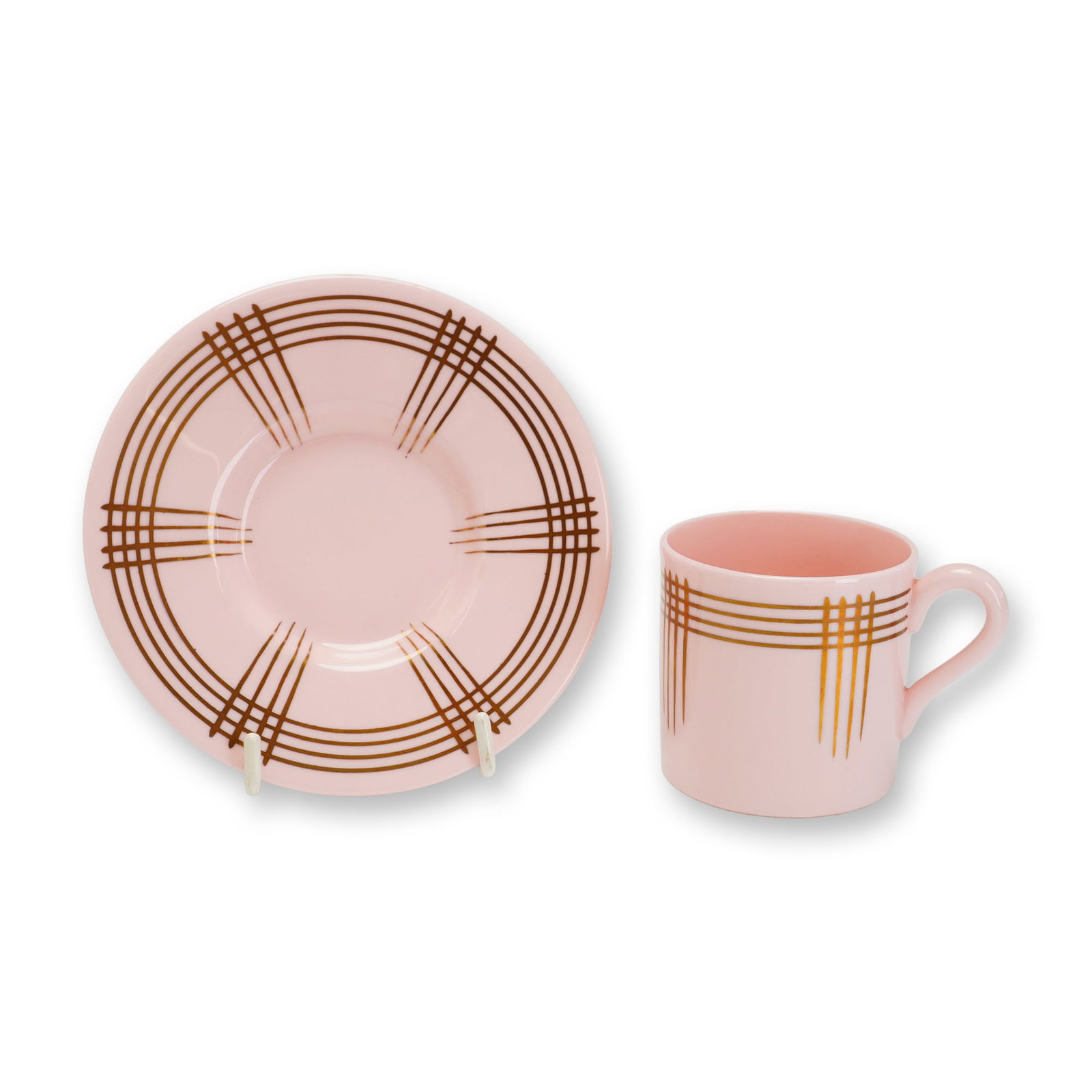 2pc Wedgwood Alpine Pink Demitasse Cup and Saucer Set: This demitasse cup and saucer set is manufactured from Wedgwood Alpine Pink bone china, featuring a translucent solid pink body. Both pieces are decorated with a gilt Art Deco geometric pattern. The s