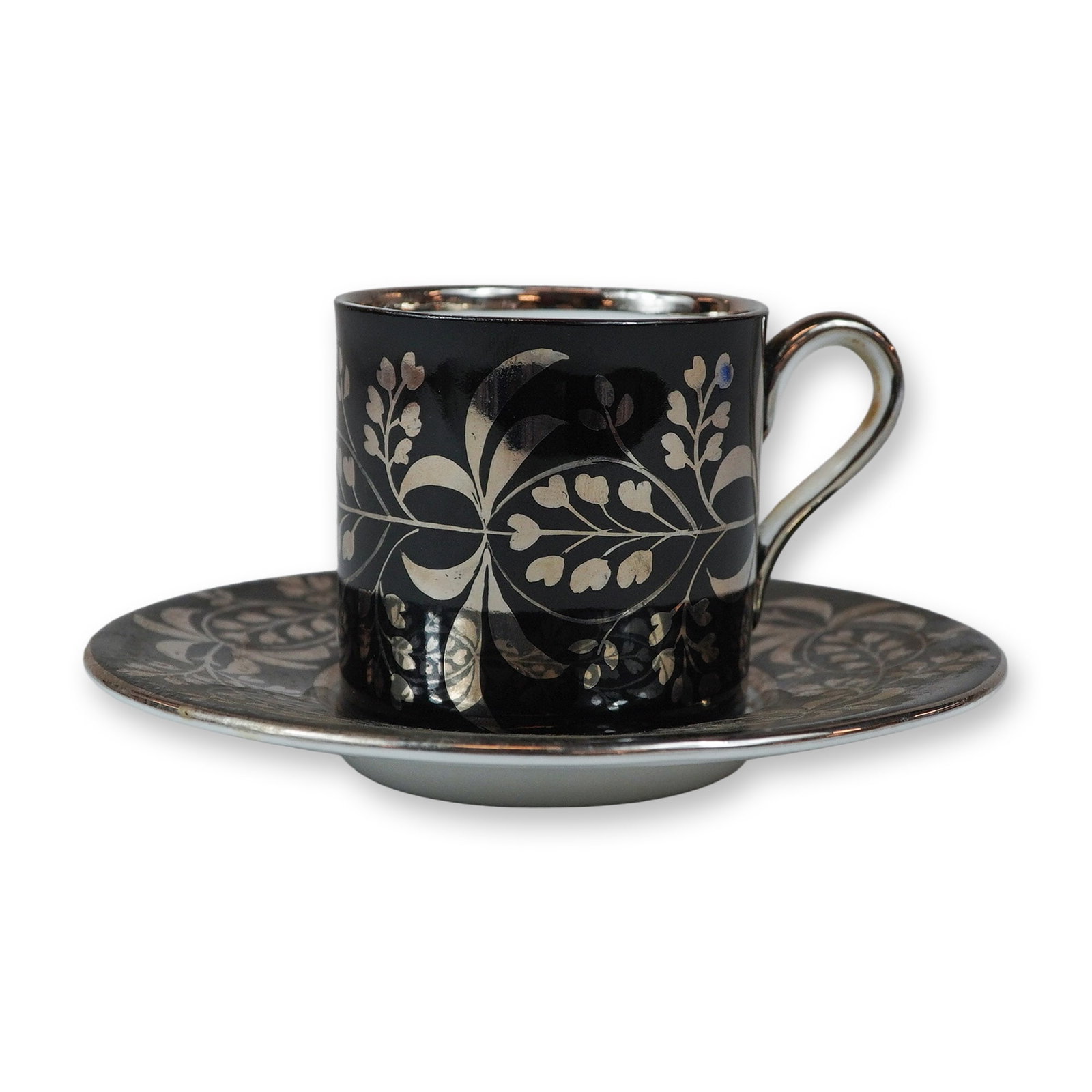 2pc Wedgwood Silver Luster Resist Demitasse Cup and Saucer Set: This fine bone china demitasse cup and saucer set by Wedgwood is decorated using a silver luster resist technique. The exterior of the straight-sided cup and the border of the matching saucer feature 
