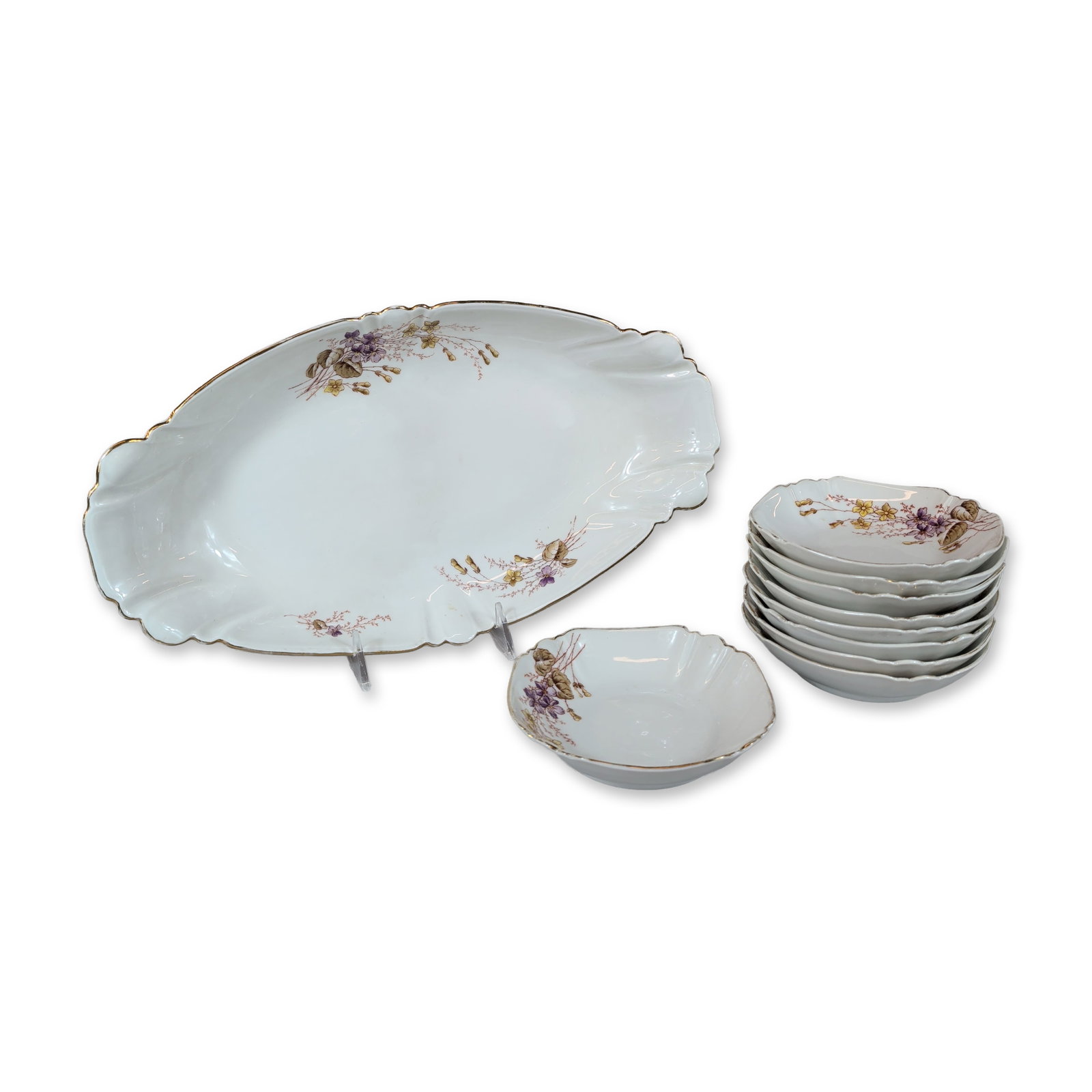 10pc Austrian Porcelain Platter and Bowls: Austrian white glazed porcelain featuring scalloped, undulating rims finished with a fine gold-gilt line. Decoration consists of transfer-printed floral sprigs in shades of purple, yellow, and tan. Th