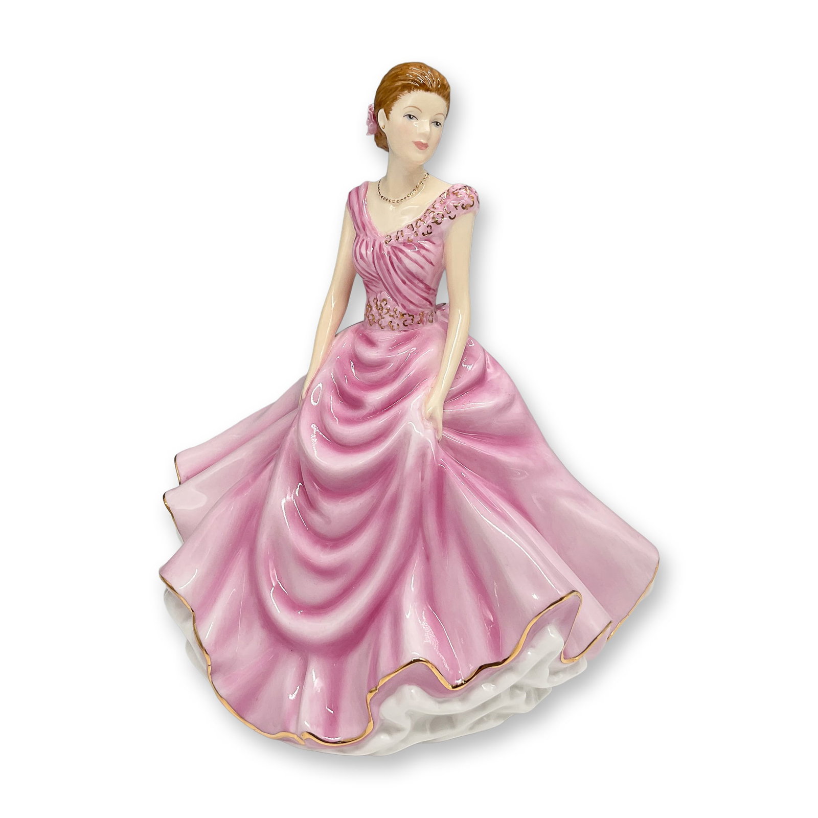 Royal Doulton Figurine, Donna HN5590: Royal Doulton porcelain figurine Donna, Petite Figure of the Year 2013, HN5590. Elegantly hand-decorated in bone china, this figurine features a woman in a flowing pink gown with gold trim, adorned wi