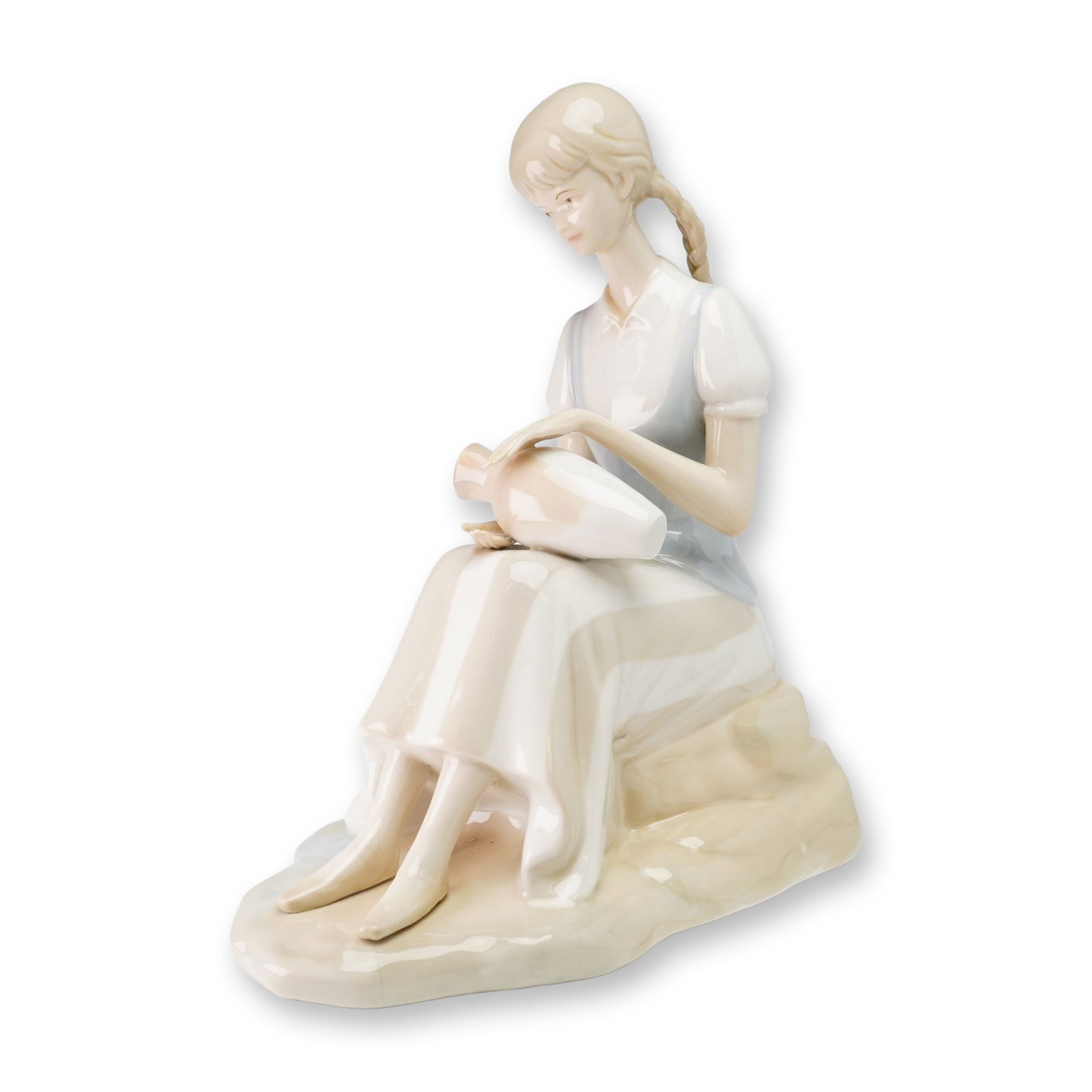 Italian Porcelain Figurine of a Seated Girl with Pottery: This glazed porcelain figurine depicts a seated young woman with blonde hair styled in two long braids. She is dressed in a pale blue bodice over a white short-sleeved blouse and a long, pale-colored 