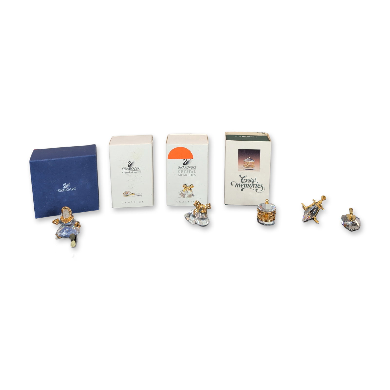 6pc Swarovski Crystal Memories Miniature Figurines: Swarovski collection of six miniature lead crystal figurines from the Crystal Memories and Classics series, featuring faceted crystal elements and gold-plated metal accents. The grouping comprises a b