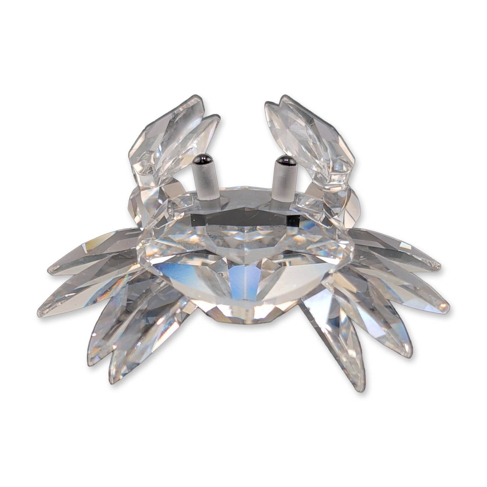 Swarovski Silver Crystal Miniature Crab Figurine: Swarovski. Miniature crab figurine in faceted clear lead crystal, part of the Silver Crystal collection. Features a multifaceted body, eight legs, and two pincers. Eyes are represented by small black 