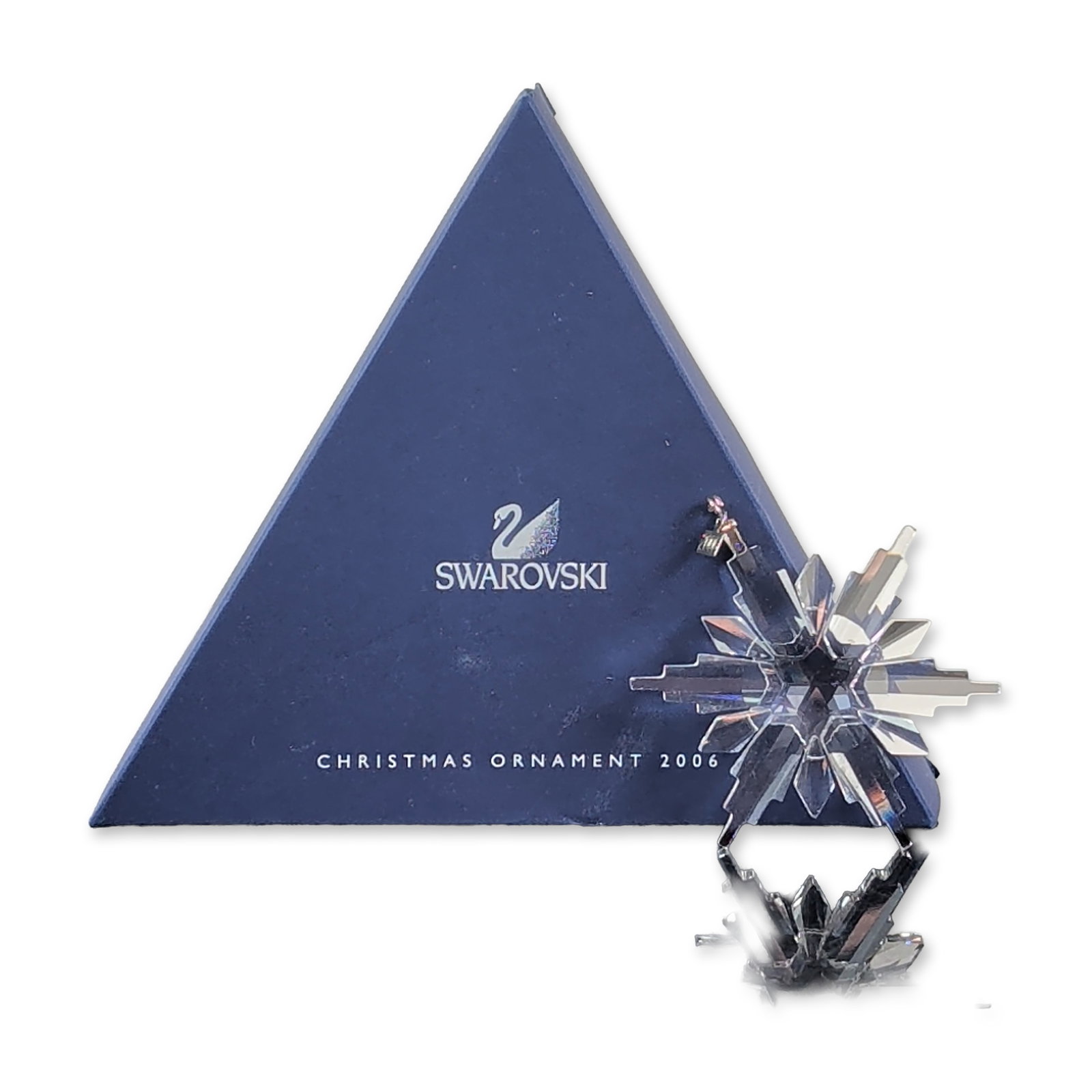 Swarovski 2006 Annual Edition Crystal Star Ornament: Swarovski 2006 Annual Edition Christmas ornament in clear faceted lead crystal, featuring a multi-tiered six-pointed star design. The piece includes a silver-tone metal hang-tag stamped with the year 