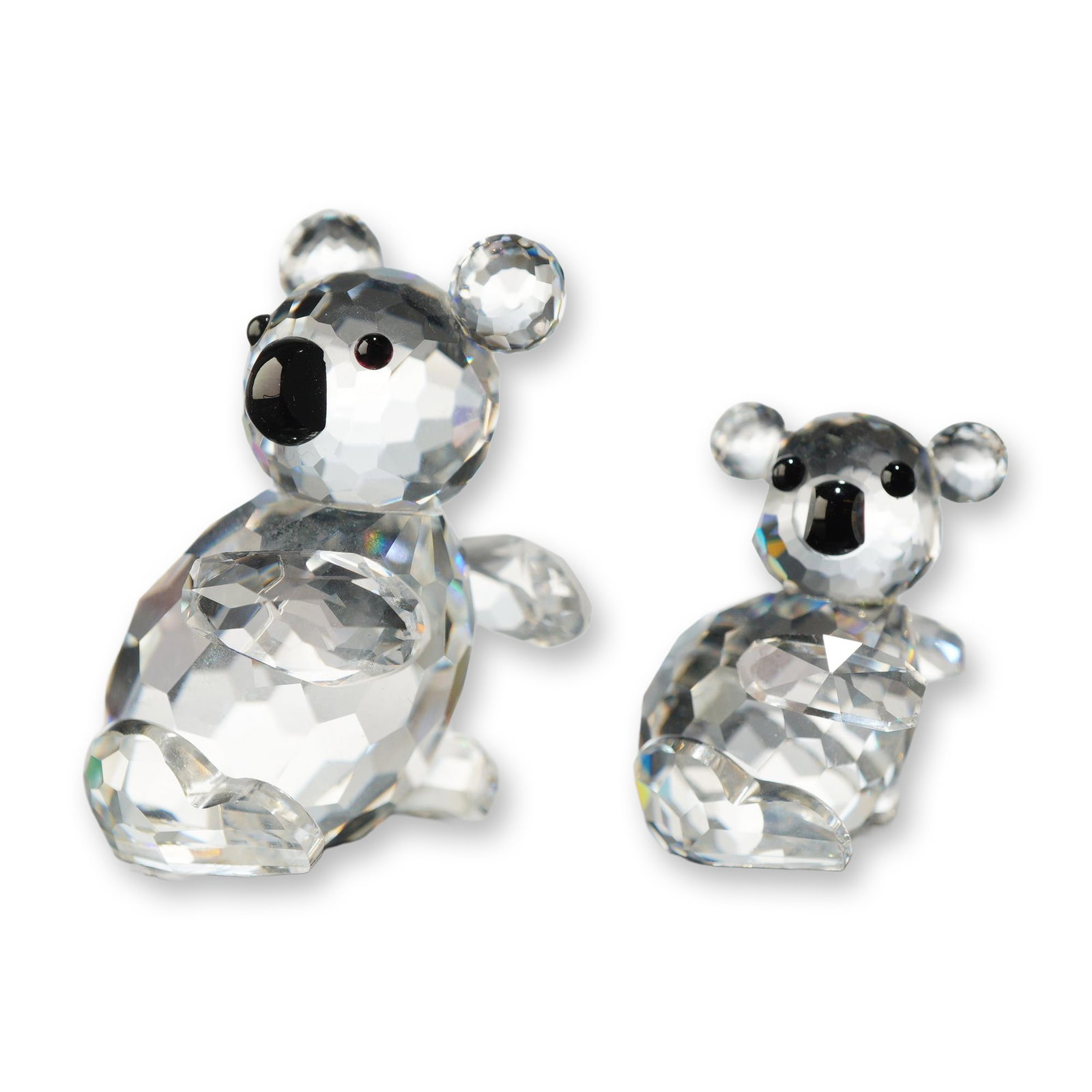 2pc Swarovski Crystal Koala and Joey Figurines: Swarovski. Pair of koala bear figurines in faceted clear lead crystal, including one larger mother koala and one smaller joey. Each figure features black crystal accents for the eyes and noses and is 