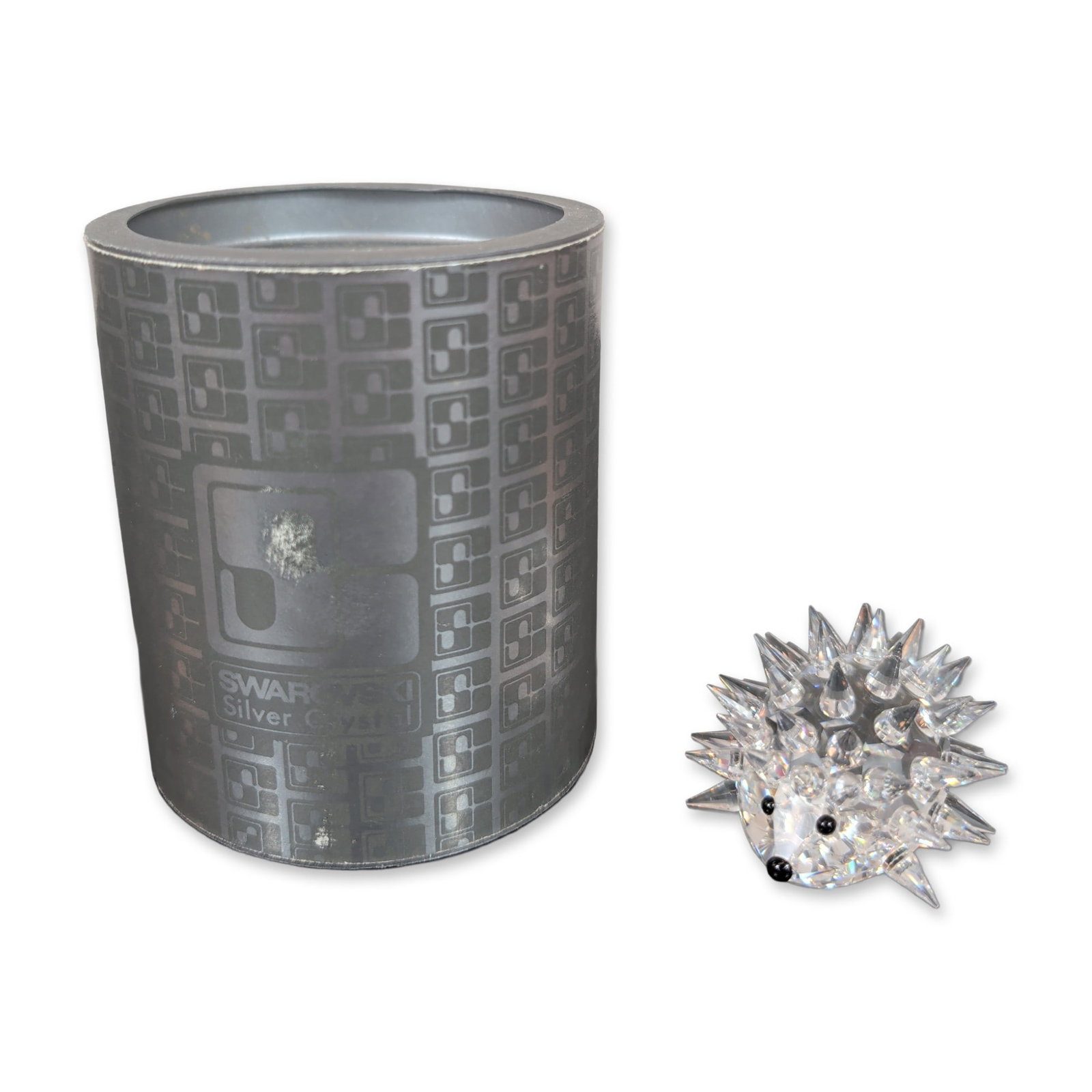 Swarovski Lead Crystal Hedgehog Figurine: Swarovski Silver Crystal collection. Hedgehog figurine in clear lead crystal, featuring a smooth face and numerous pointed, faceted crystal spikes. Three small black crystal beads represent the eyes a