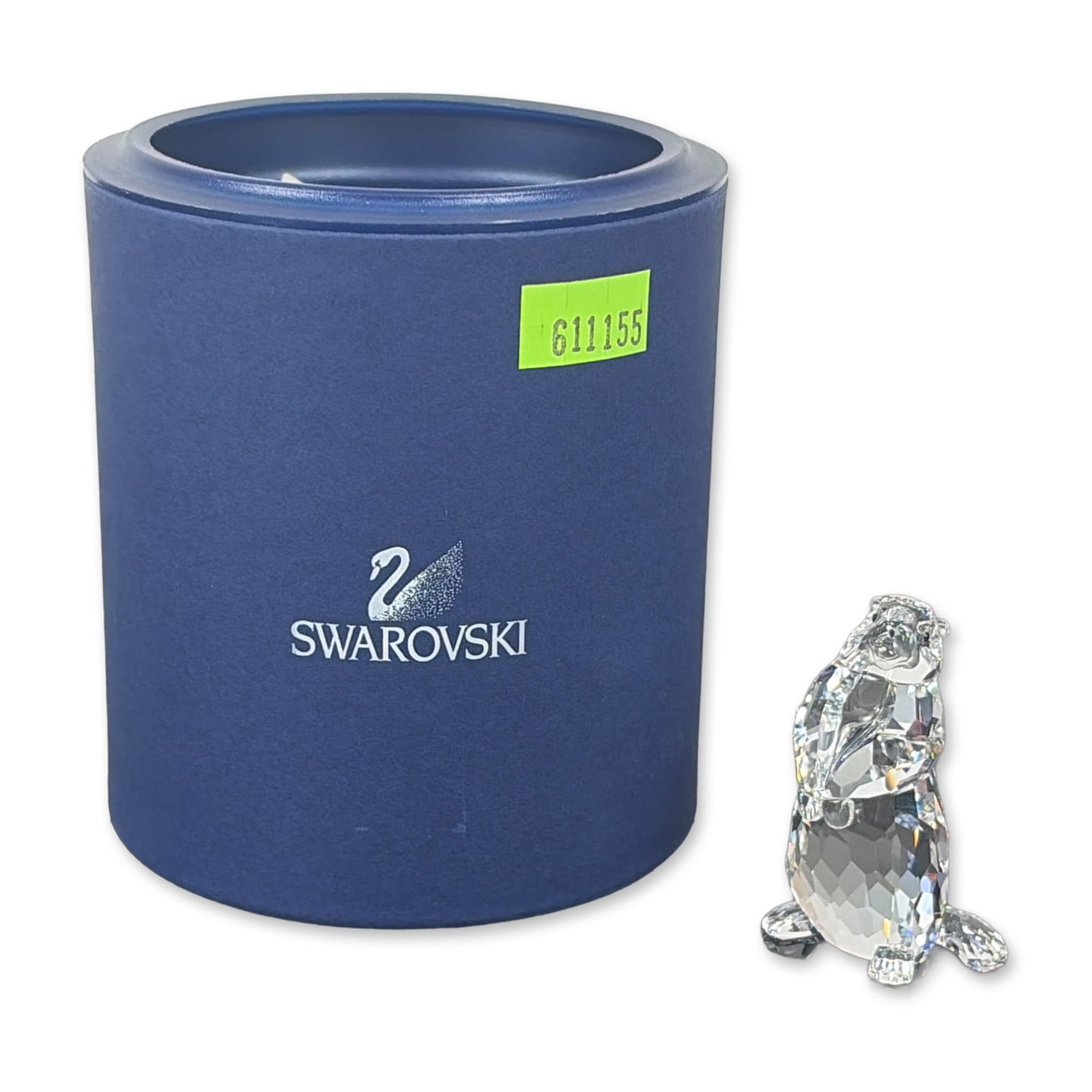 Swarovski Crystal Groundhog Figurine: This Swarovski crystal marmot is from the “Woodlands Friends” collection and crafted from clear crystal. It features an etched Swarovski swan logo and a copyright symbol on its body. It comes 