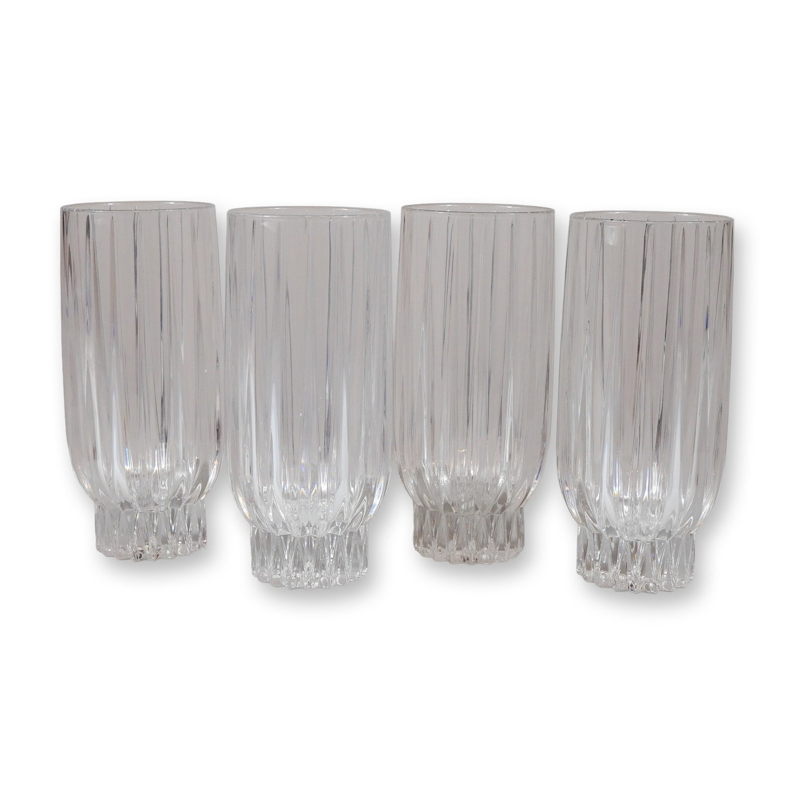 Set of 4 Crystal Water Glasses with a Heavy Ribbed Design: A set of four crystal water glasses featuring a tall cylindrical form with a heavy ribbed design. The body of each glass is decorated with polished vertical flutes that terminate at a rounded lower se