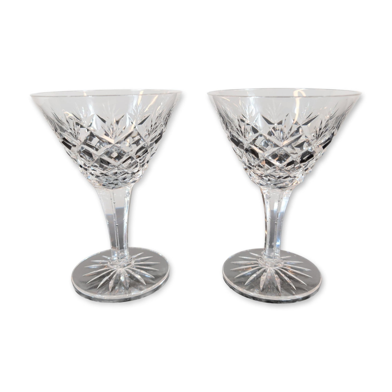 Pair of Cut Crystal Stemmed Wine Glasses: Pair of cut lead crystal stemmed glasses featuring a V-shaped bowl decorated with a cut criss-cross diamond pattern on the lower portion and vertical wedge cuts extending toward the plain rim. The mul