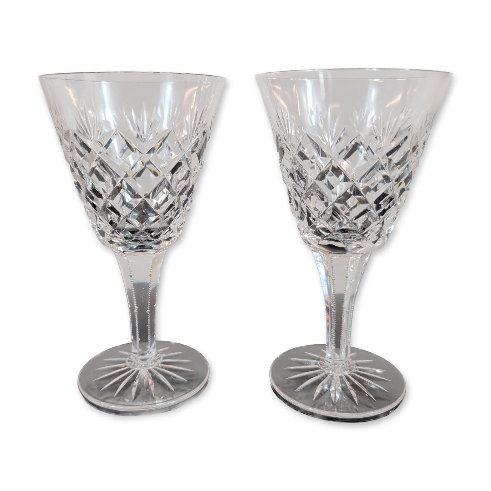 Pair of Cut Crystal Wine Glasses: Pair of cut crystal wine glasses. Each stem features a tulip-shaped bowl with a flared, polished rim, decorated with a lower band of deep criss-cross diamond cuts beneath a row of vertical wedge