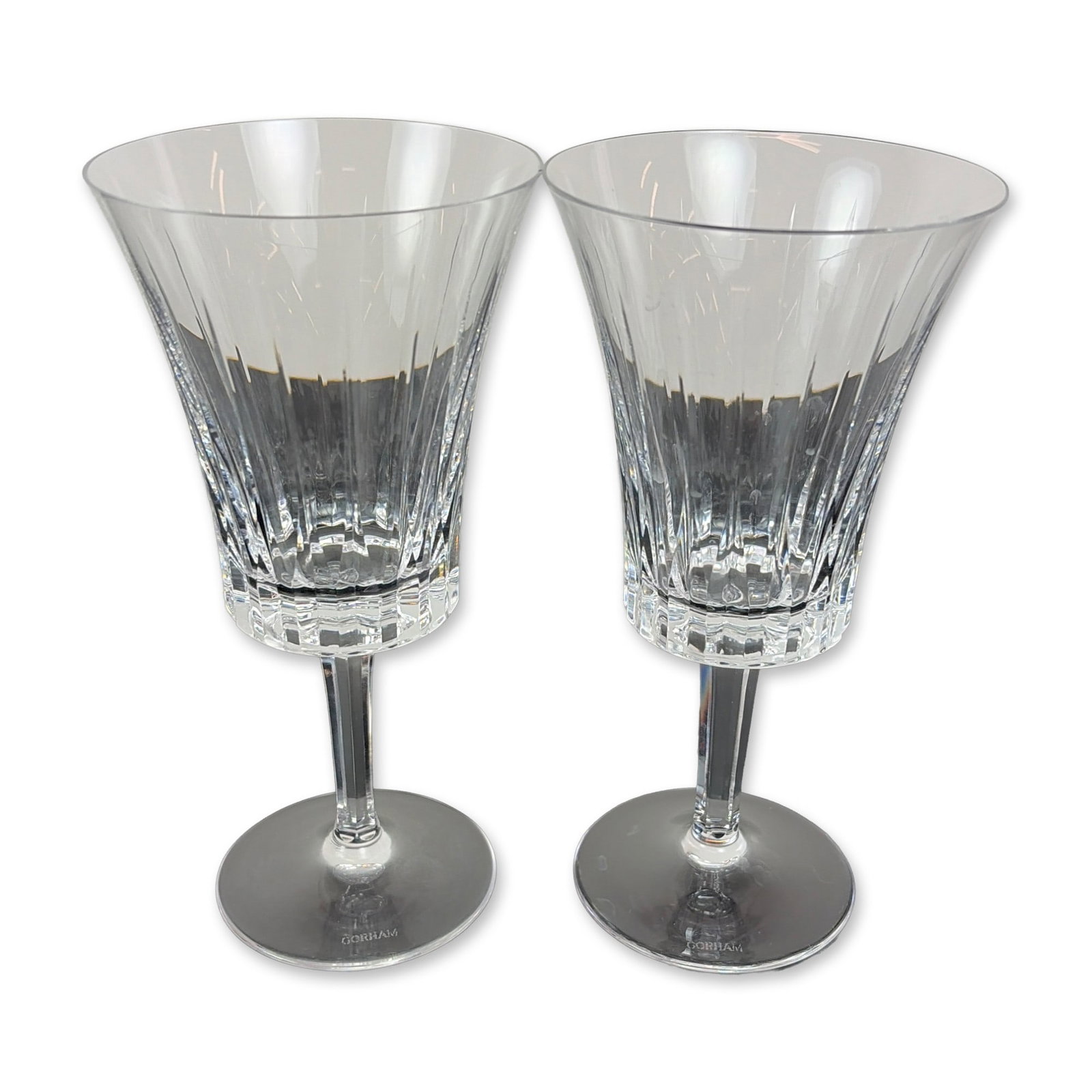 Pair of Gorham Crystal Water Goblets, Richelieu-Rondo: Each lead crystal glass features a flared bell-shaped bowl decorated with deep vertical wedge cuts and a faceted band at the base. Supported by a multi-faceted stem on a plain circular foot. Acid-etch