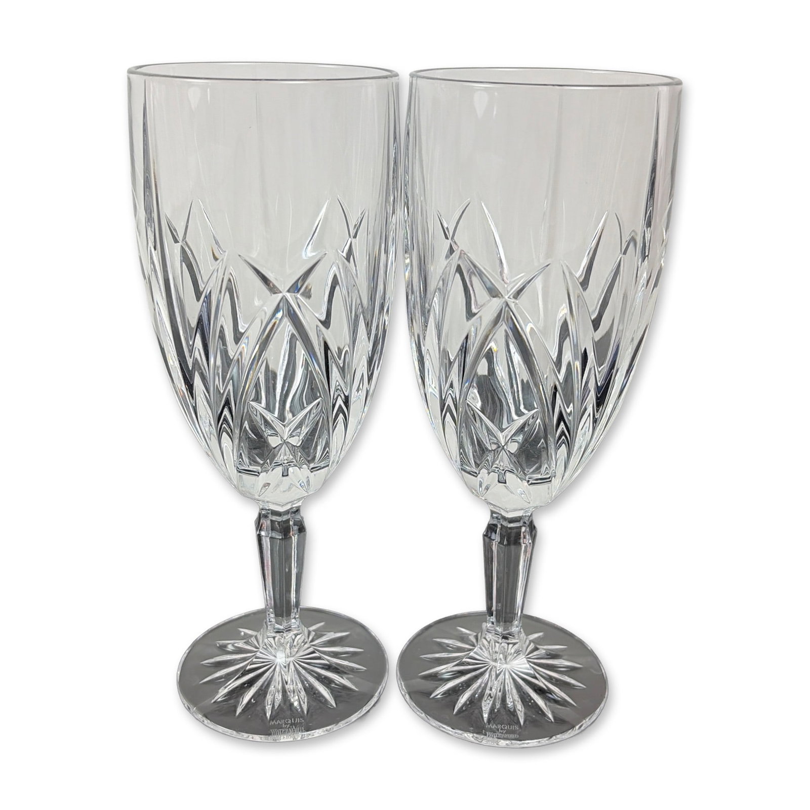 Pair of Marquis by Waterford Crystal Brookside Iced Tea Glasses: Each bowl features a lower register of deep-cut crisscross diamond motifs beneath upright wedge cuts. The design includes a multi-faceted stem and a circular foot with an underside starburst cut. Both