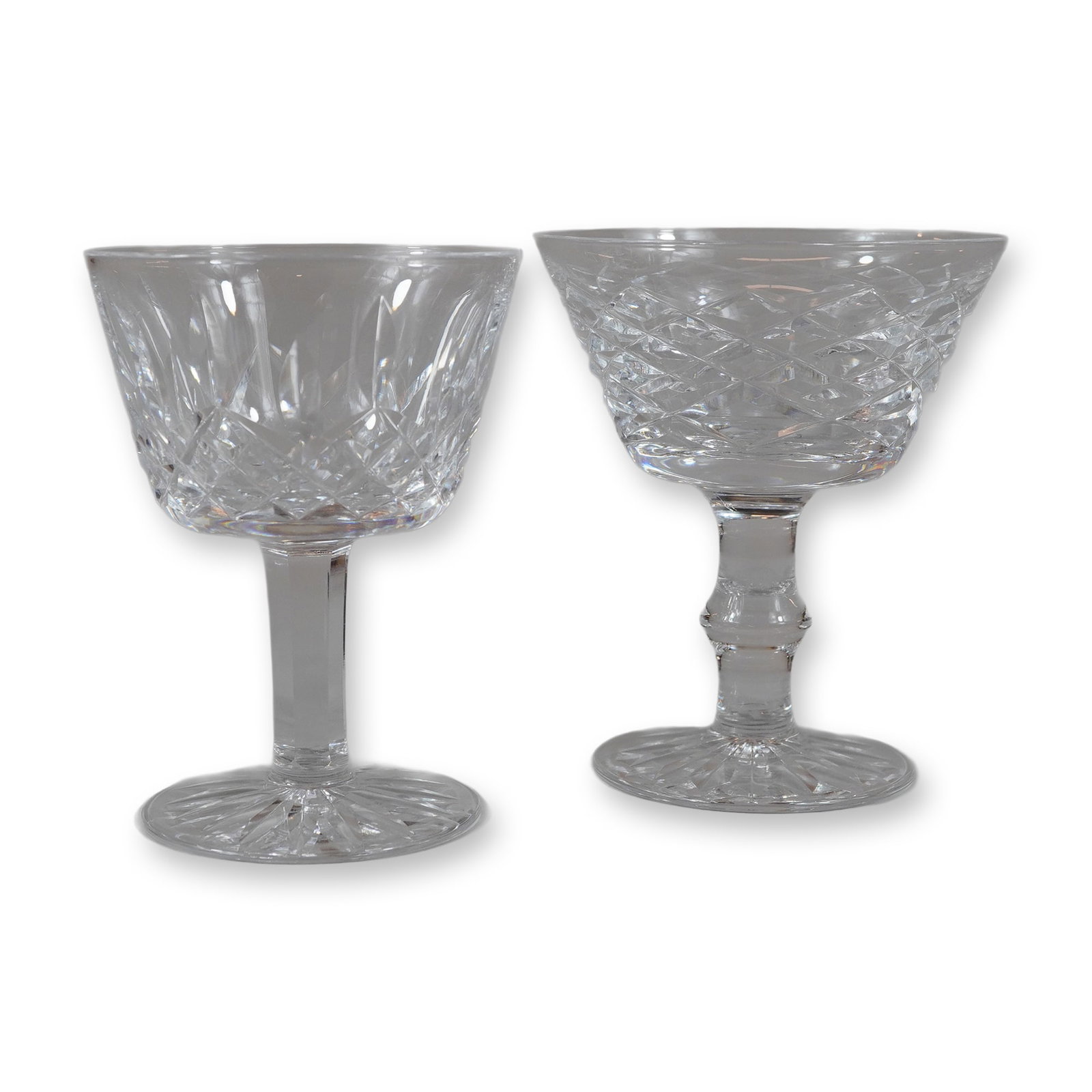2pc Waterford Crystal Glasses Liqour Glasses, Lismore and Tyrone: This lot consists of two lead crystal glasses manufactured by Waterford, featuring two distinct cutting patterns. The first glass is in the Lismore pattern, which is decorated with deep-cut diamonds o