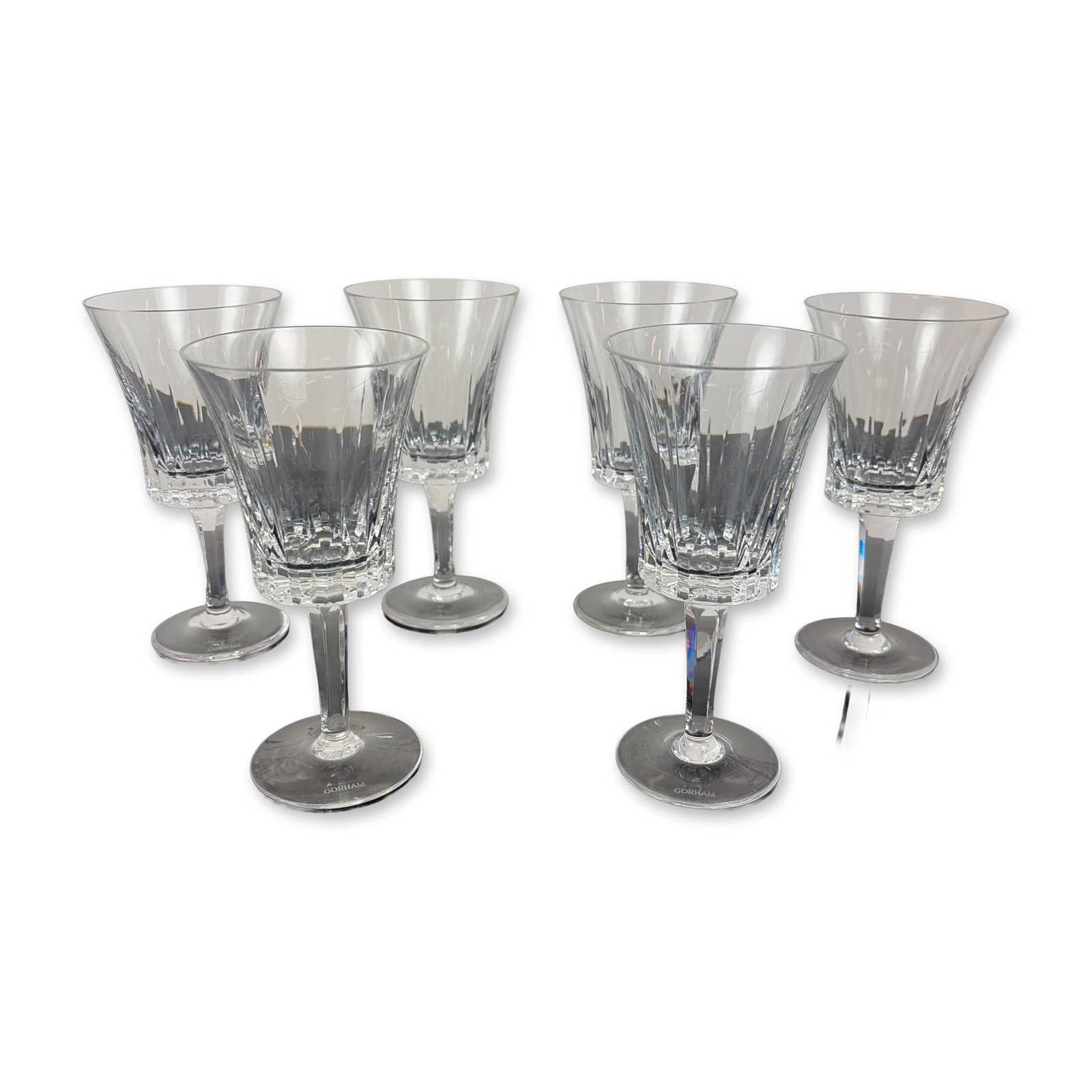 Set of Six Gorham Richelieu-Rondo Crystal Wine Glasses: Each glass features vertical wedge cuts on the upper portion of the bowl transitioning into a deeply faceted, paneled base. The faceted, multisided stems lead to a plain circular foot. Each piece is m
