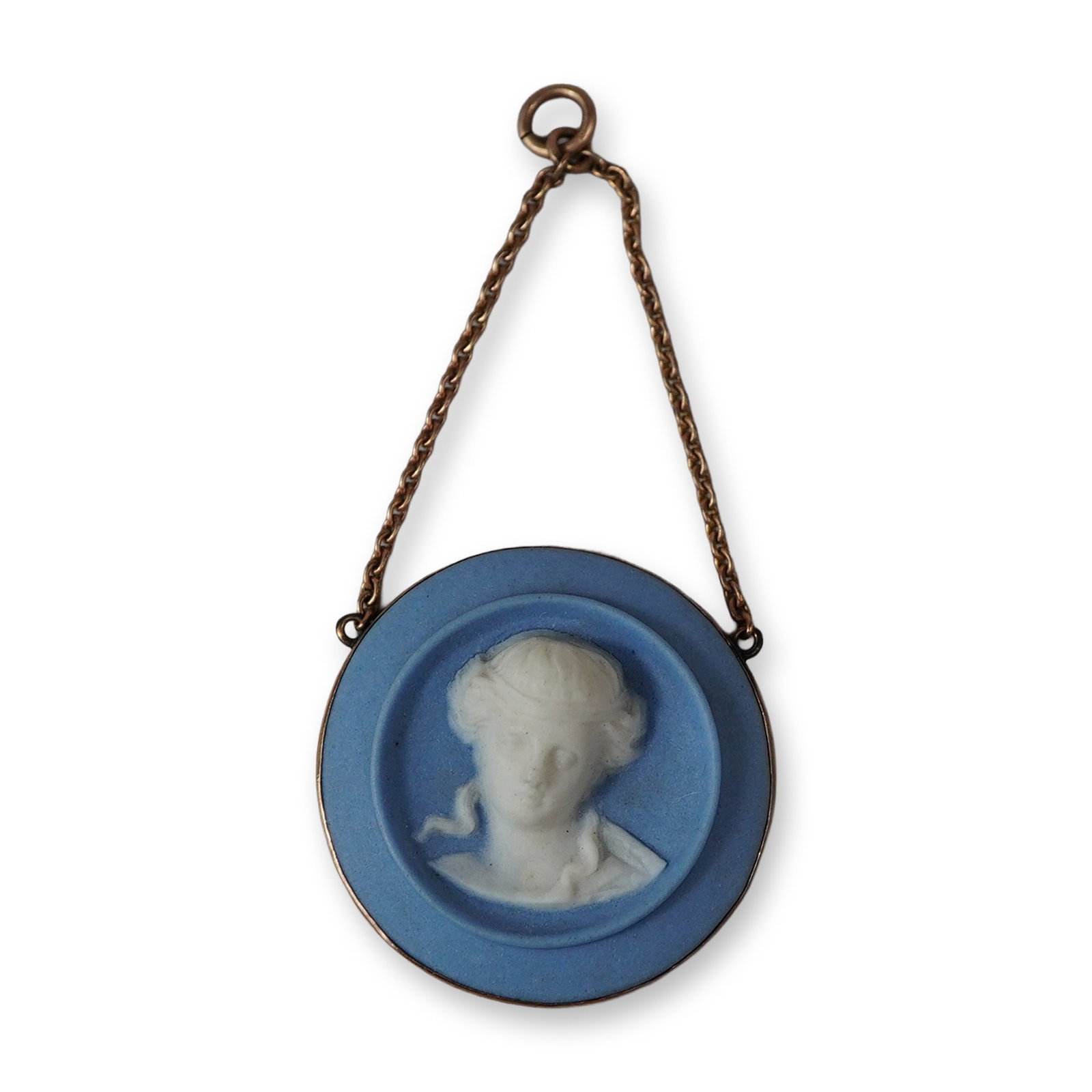 Wedgwood Blue and White Jasperware Cameo Pendant: A Wedgwood jasperware cameo pendant featuring a white relief classical female bust against a matte blue ground. The circular ceramic cameo is set in a yellow metal bezel and suspended from a short yel