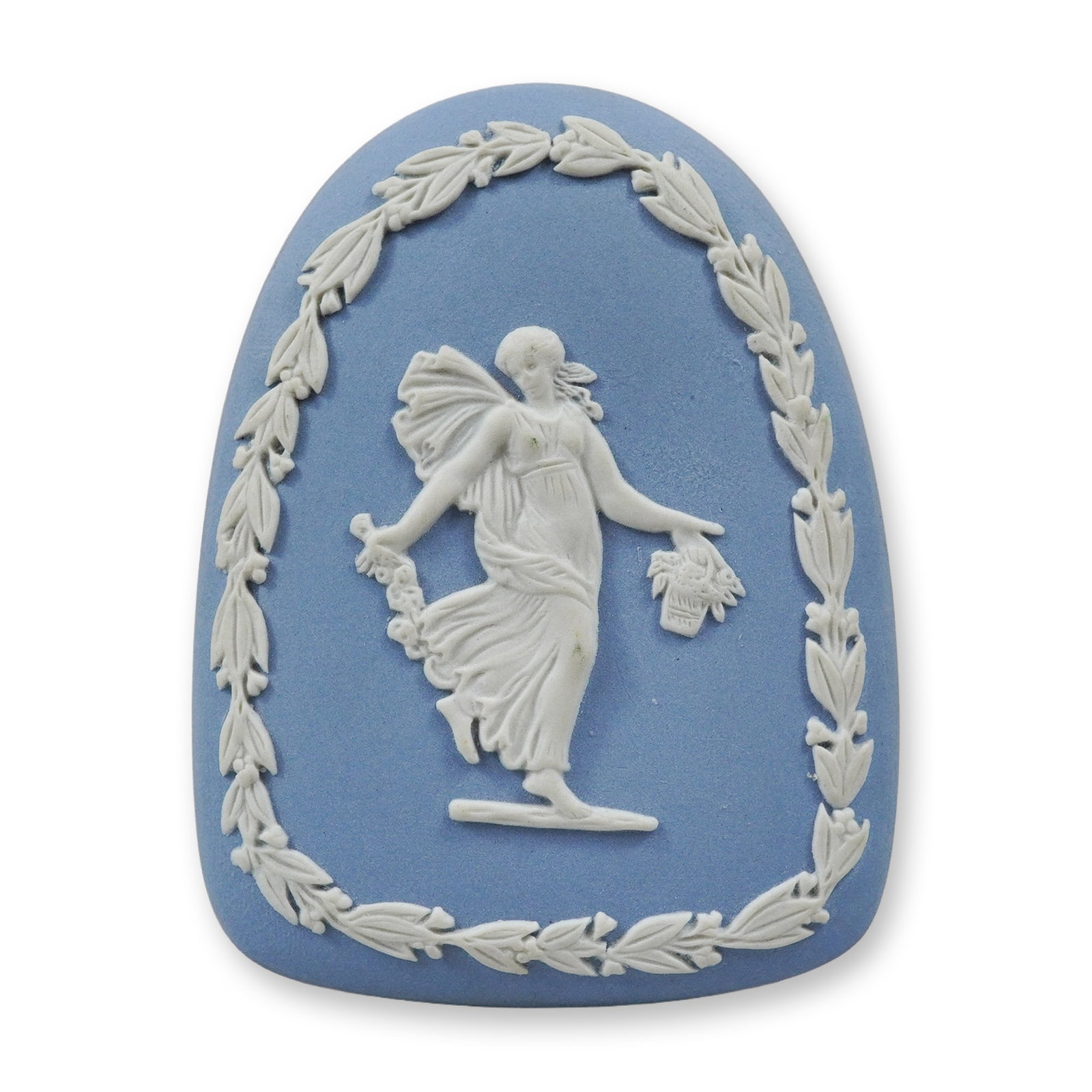 Wedgwood Blue Jasperware Arched Plaque with Classical Figure: A Wedgwood Jasperware arched plaque featuring a light blue stoneware body with white sprigged relief ornamentation. The central motif depicts a classical female figure in flowing robes carrying a