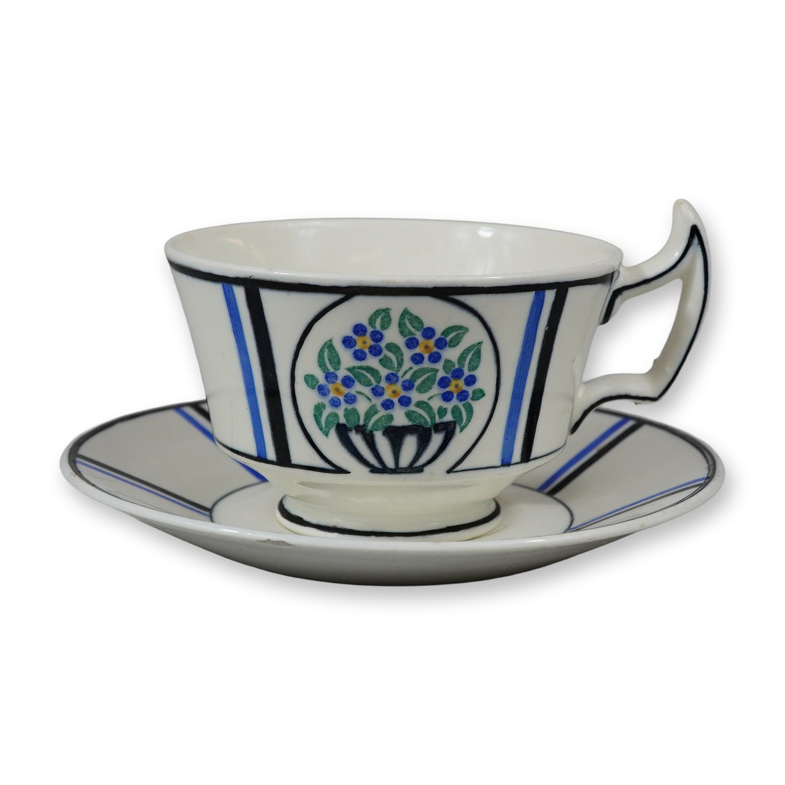 2pc Wedgwood Art Deco Basket of Flowers Pattern Teacup and Saucer: This teacup and saucer set is crafted from cream-colored earthenware, known as Queensware, by Wedgwood. The design reflects the Art Deco period, featuring hand-painted decoration. Each piece is center