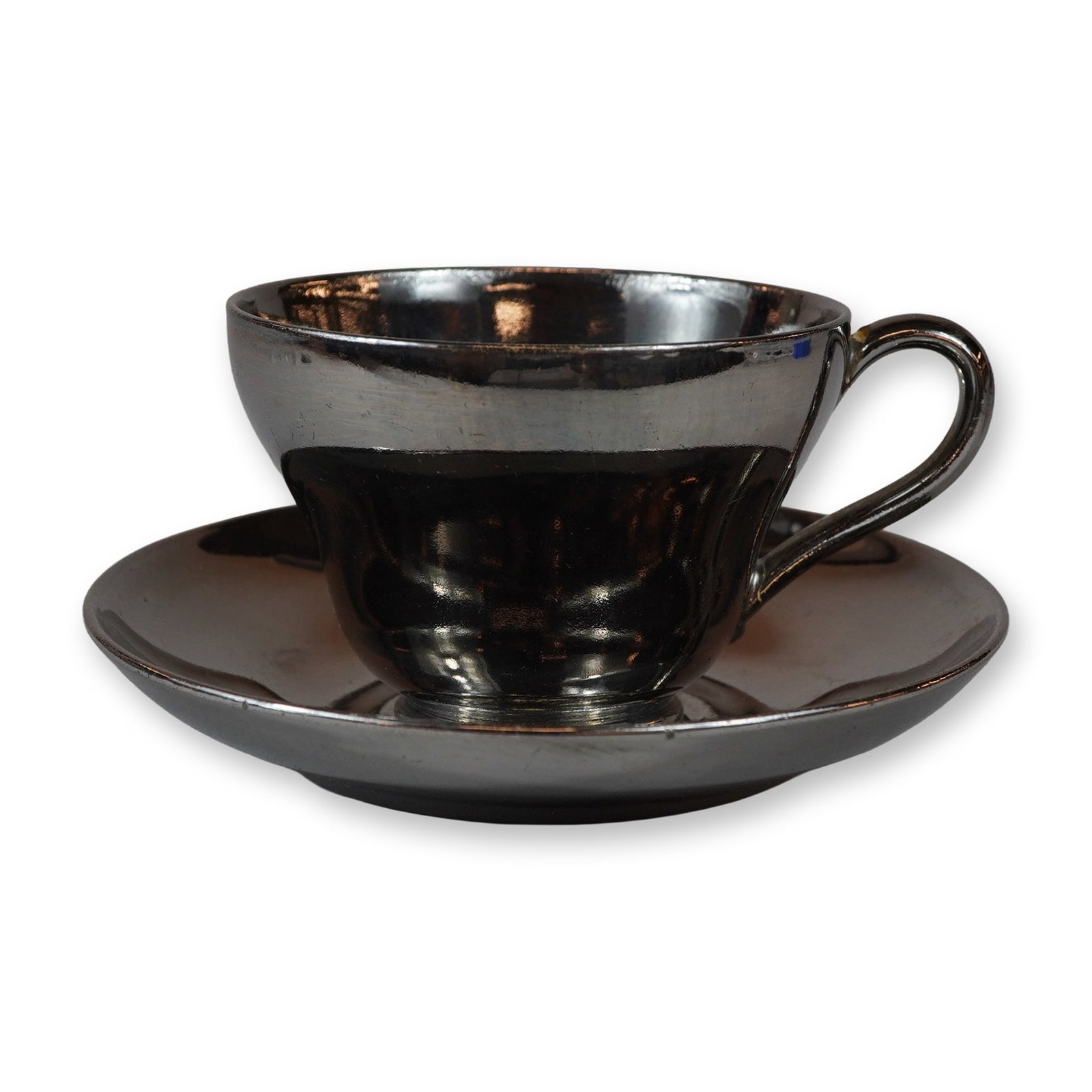 2pc Wedgwood Silver Luster Teacup and Saucer: This ceramic set consists of a teacup and matching saucer manufactured by Wedgwood at the Etruria works in England. Both pieces are made of fine earthenware and feature an overall solid silver-colored