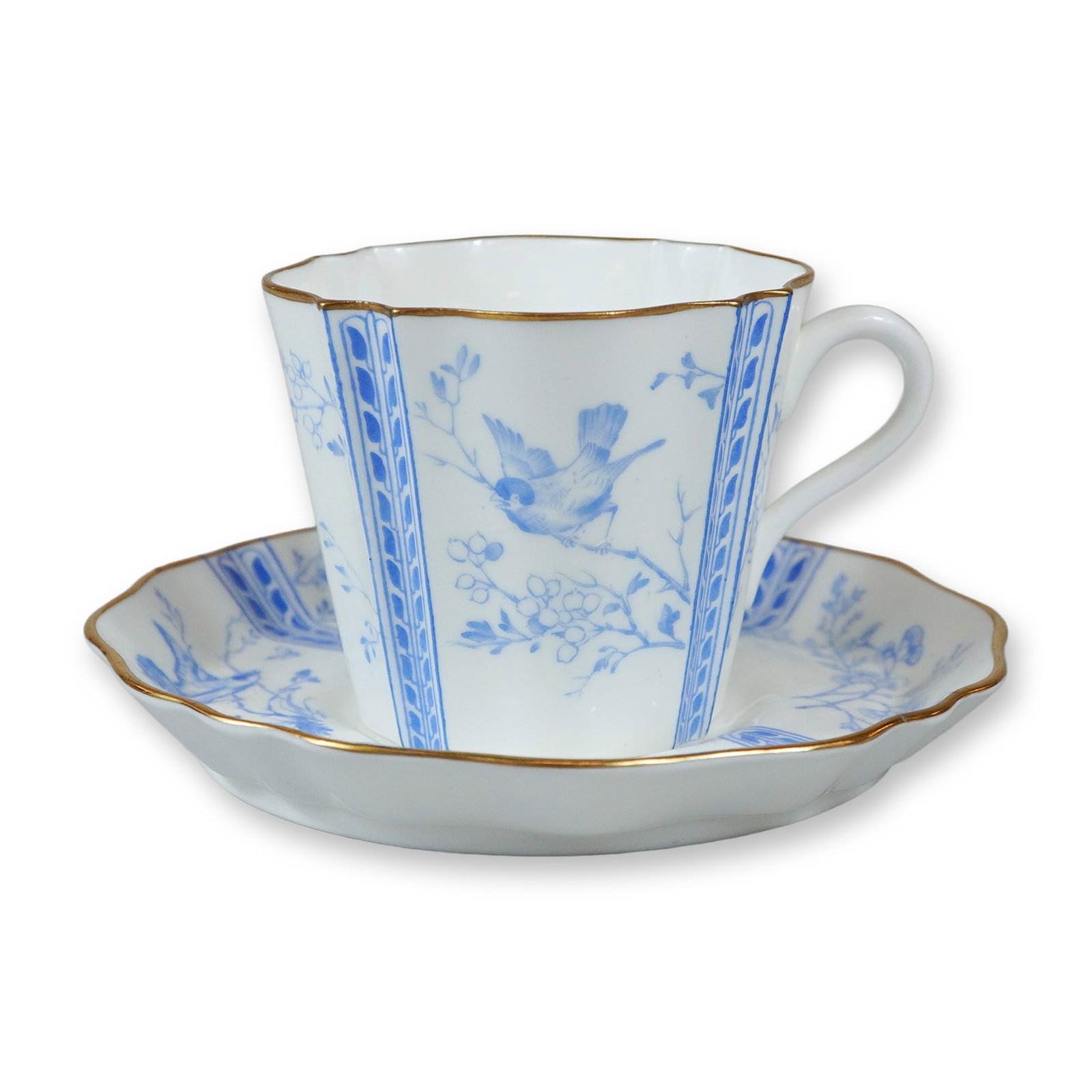 2pc Wedgwood Porcelain Cup and Saucer: This fine bone china cup and saucer set was manufactured by Wedgwood in England. The pieces feature pattern Y2715, which is characterized by blue transfer-printed ornithological and botanical motifs. 