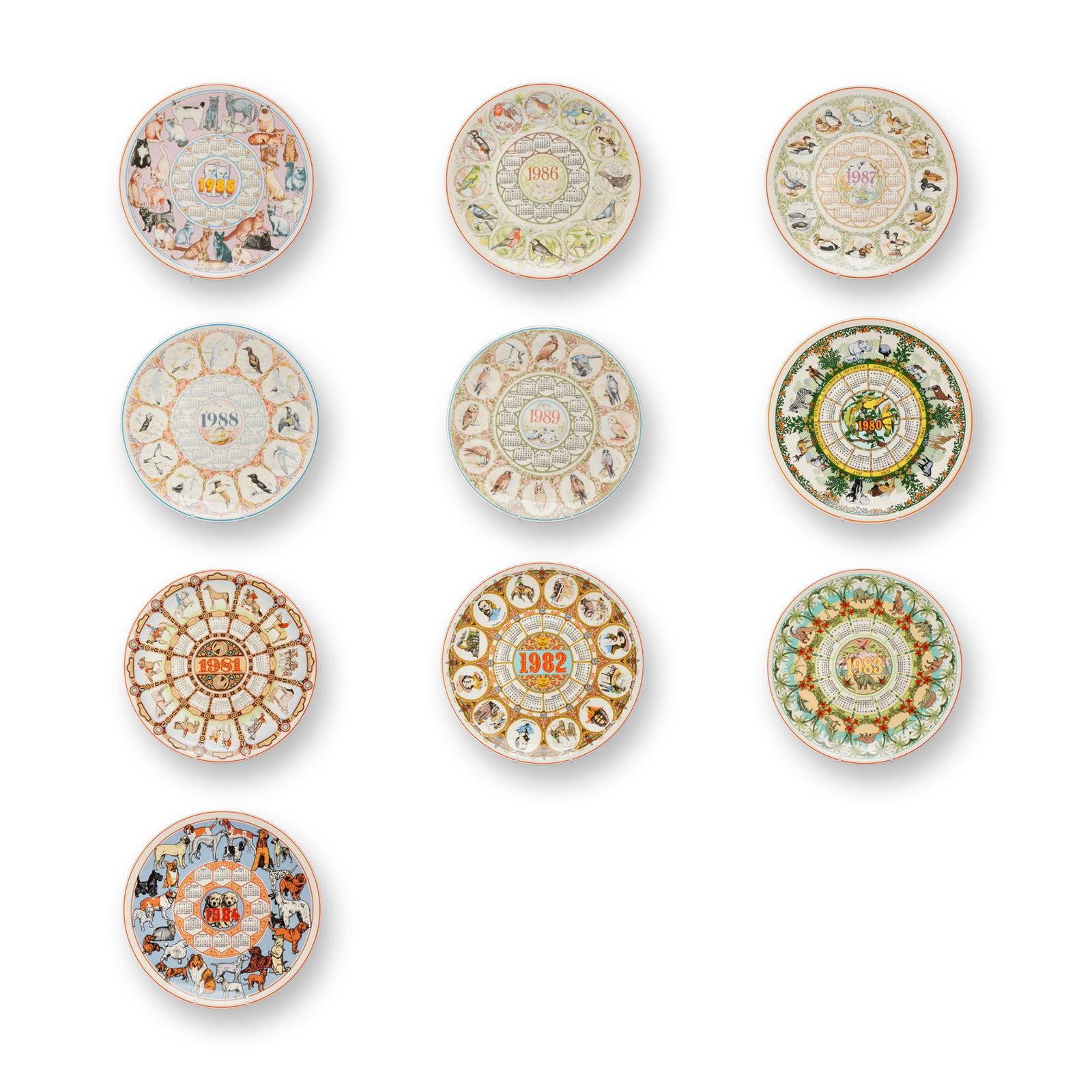 10pc Wedgwood Ceramic Calendar Plates 1980-1989: A collection of ten ceramic calendar plates manufactured by Wedgwood, covering each year of the decade from 1980 to 1989. Each plate is designed with a central year and a circular 12-month calendar bo
