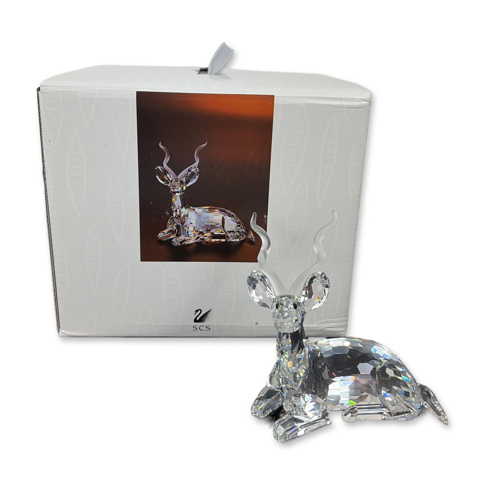 Swarovski Inspiration Africa Signed Crystal Kudu Figurine: Swarovski Kudu figurine from the SCS 1994 Annual Edition Inspiration Africa series, in faceted clear lead crystal with frosted spiral horns and black crystal eyes. Etched with Swarovski swan logo and 