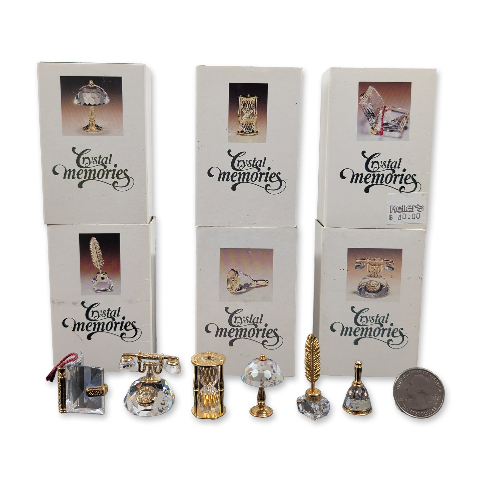 6pc Collection of Swarovski Crystal Memories Style Miniature Figurines: Swarovski Crystal Memories collection of miniature figurines in faceted clear crystal with gold-tone metal accents. The grouping includes desk and office-themed forms including a rotary telephone, an 