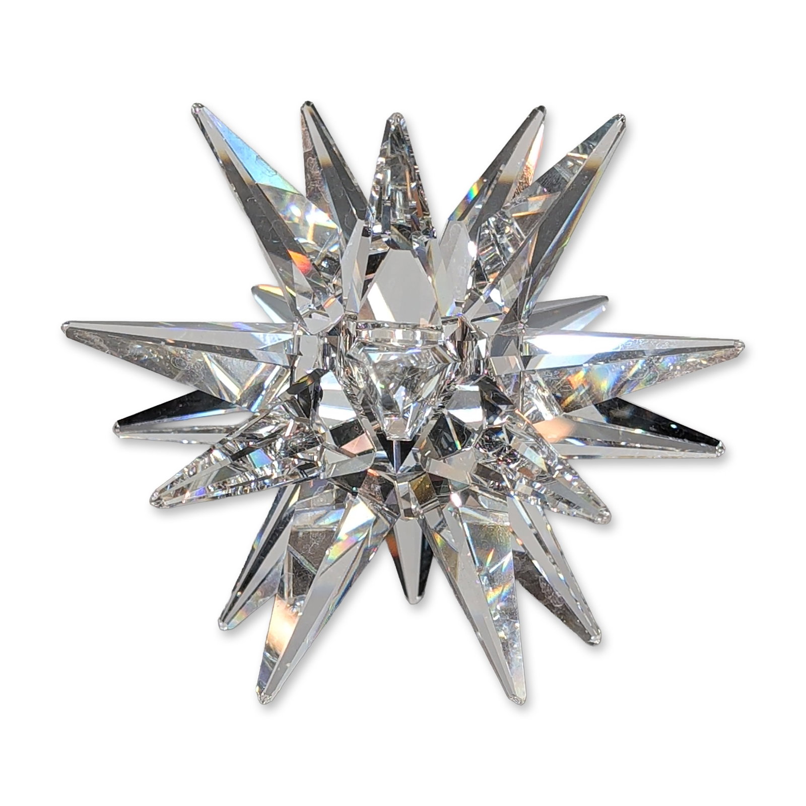 Swarovski Silver Crystal Large Star Candle Holder: Swarovski Silver Crystal large faceted star candle holder. Clear lead crystal construction featuring a multi-pointed starburst form with a central recessed candle well designed to catch and refract li