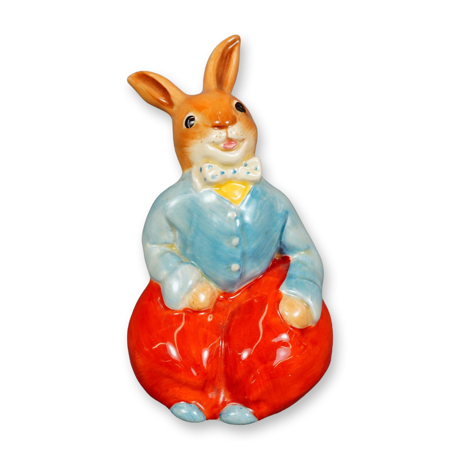 Royal Doulton Bunnykins Figurine, Billy Bunnykins: Hand painted figure of a bunny dressed in a red pants, blue shoes and sweater, and white bowtie with blue dots. Royal Doulton and Bunnykins backstamp. Dimensions: 3.25"L x 2.75"W x 4.25"H Manufacturer