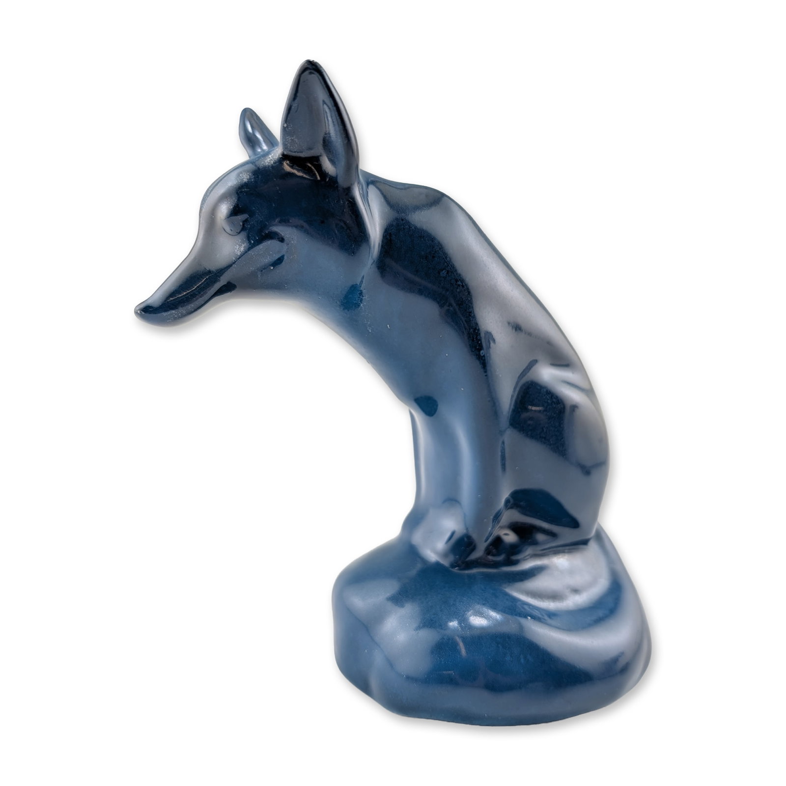 Royal Doulton Rare Blue Glazed Porcelain Figurine, Fox Seated HN147C: Royal Doulton, England. A stylized figurine of a seated fox, featuring a sleek modernist form with the head turned downward. The piece is finished in a uniform high-gloss navy blue glaze. The undersid