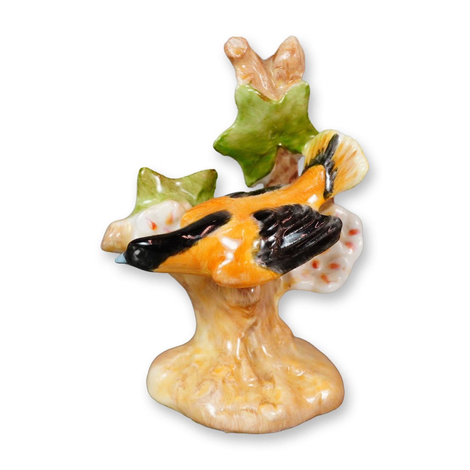Royal Doulton Bone China Bird Figurine, Baltimore Oriole K29: Hand-painted figure of an orange and black bird perched beside white and orange blossoms, rendered with fine detail and vibrant coloration. Marked with the Royal Doulton backstamp on the underside. Di