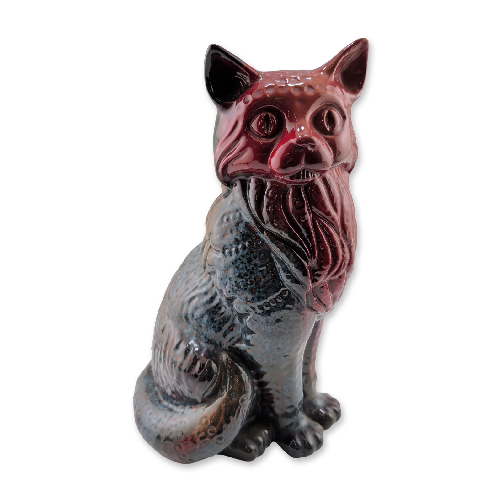 Royal Doulton Flambe Sung Colored Seated Cat Figurine: Large seated cat figurine in glazed porcelain, featuring a stylized expression and textured coat finished in a veined flambe glaze. The glaze transitions from a deep sang de boeuf red at the head to a