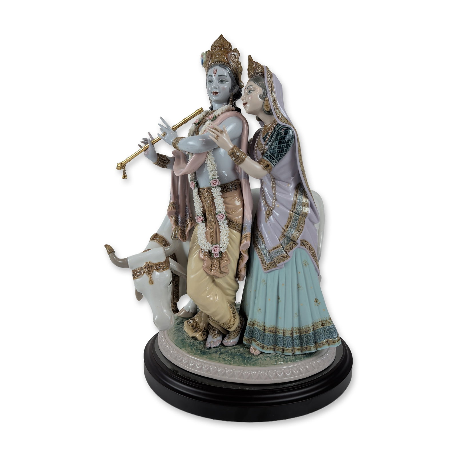 Lladro Limited Edition Radha Krishna Porcelain Sculpture: Lladro (Spain). Large-scale limited edition glazed polychrome porcelain sculpture titled Radha Krishna, featuring the Hindu deities standing beside a white cow. The figures are rendered with tradition