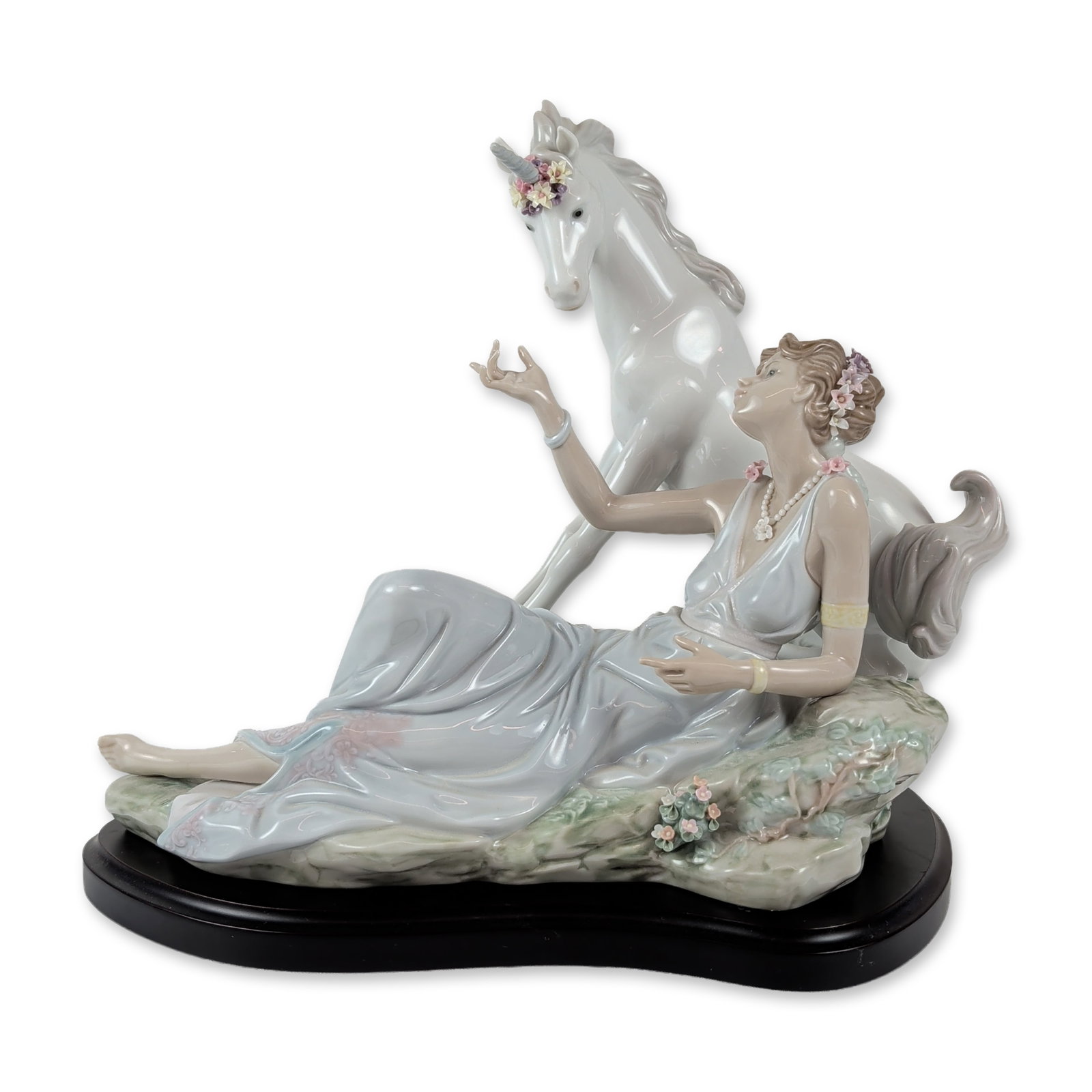Lladro Spanish Porcelain Goddess and Unicorn Figurine: Lladro, Spain. Large glazed porcelain figurine titled The Goddess and the Unicorn, model number 6007. The composition features a woman in a flowing pale blue classical gown reclining on a rocky outcro