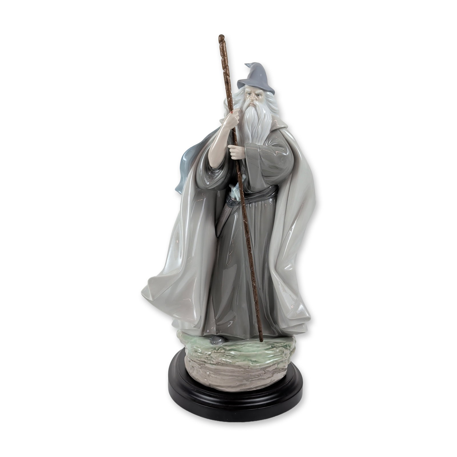 Lladro Limited Edition Gandalf Porcelain Figurine: Lladro, Spain. Glazed porcelain figurine of Gandalf the Grey from The Lord of the Rings collection, model number 010.08052. The wizard is modeled in grey robes and a pointed hat holding a textured sta