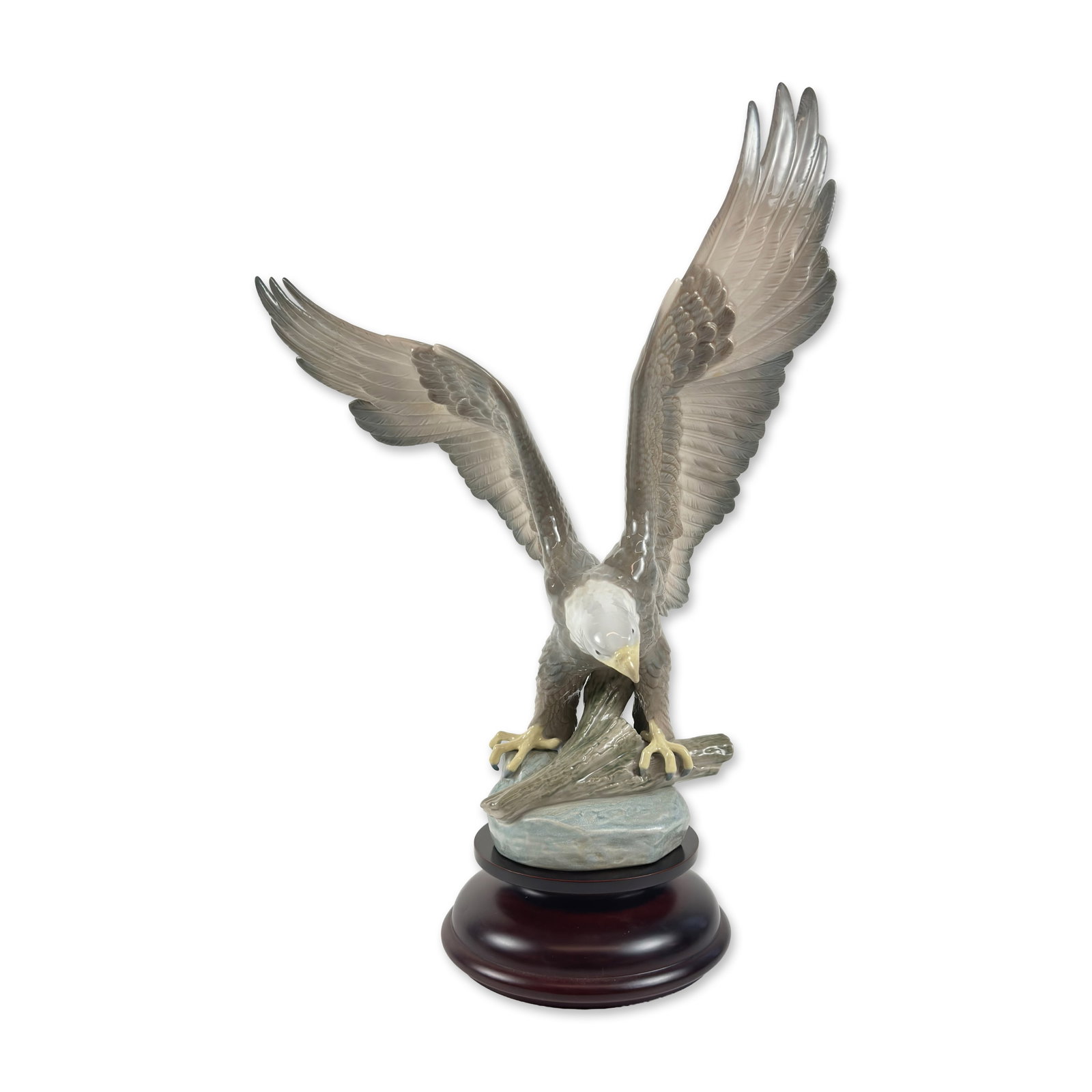 Lladro Liberty Eagle Limited Edition Porcelain Figurine: Lladro (Spain, 20th century). Large glazed porcelain sculpture titled Liberty Eagle, reference number 1738, depicting a bald eagle with wings outspread landing on a weathered tree branch atop a rocky 