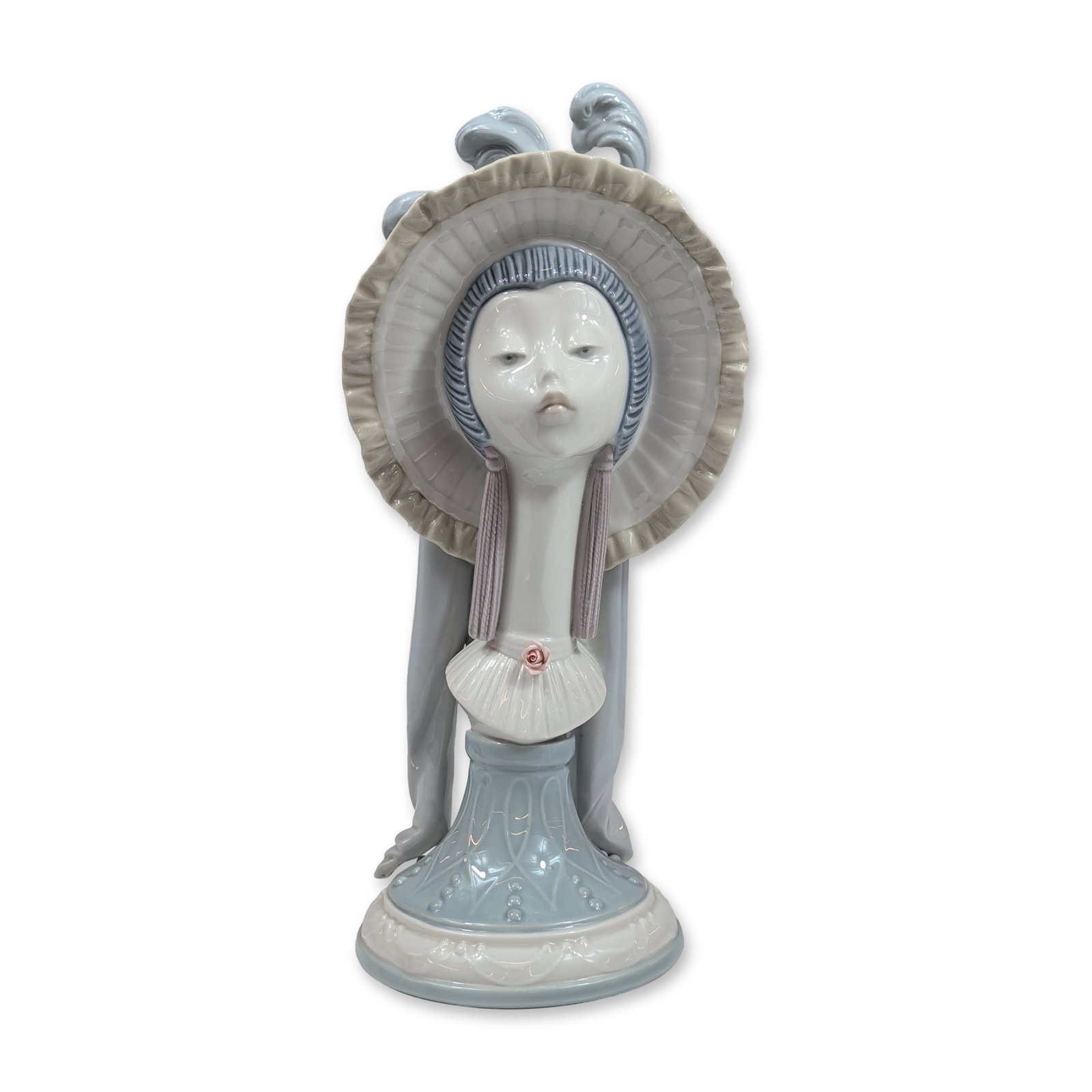 Lladro Porcelain Girl's Head Bust 5153: Spanish Lladro glazed porcelain bust depicting a lady in a wide-brimmed ruffled hat with plumes. The figure is designed with an elongated neck and features a ruffled collar accented by a single,