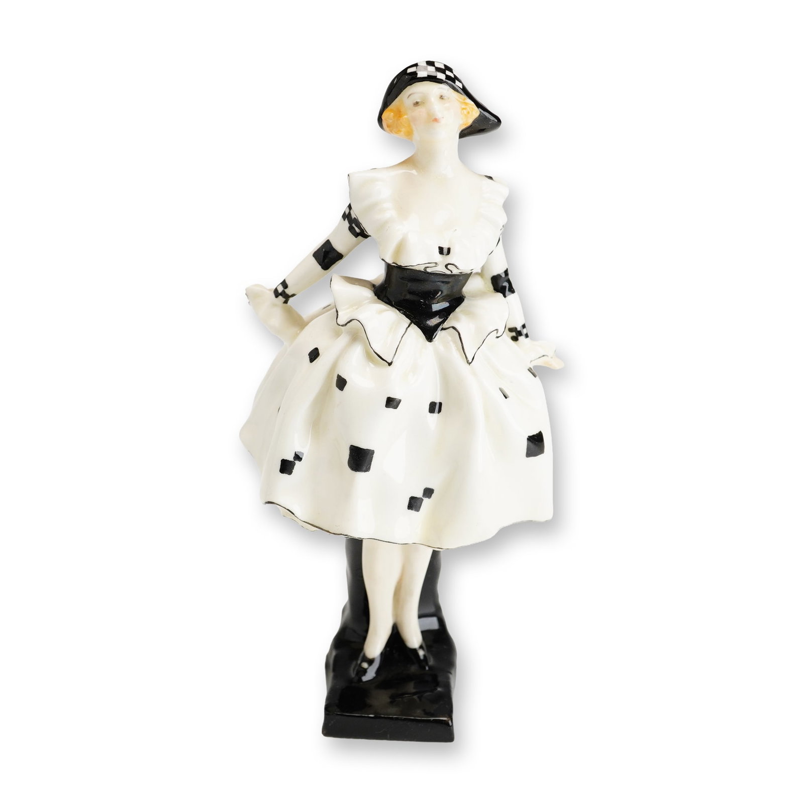 Royal Doulton Porcelain Figurine, Harlequinade HN711: Part of the Commedia dell'Arte series designed by Leslie Harradine, this hand-painted black and white figure draws inspiration from the British theatrical tradition of Harlequinade. Finished with the 