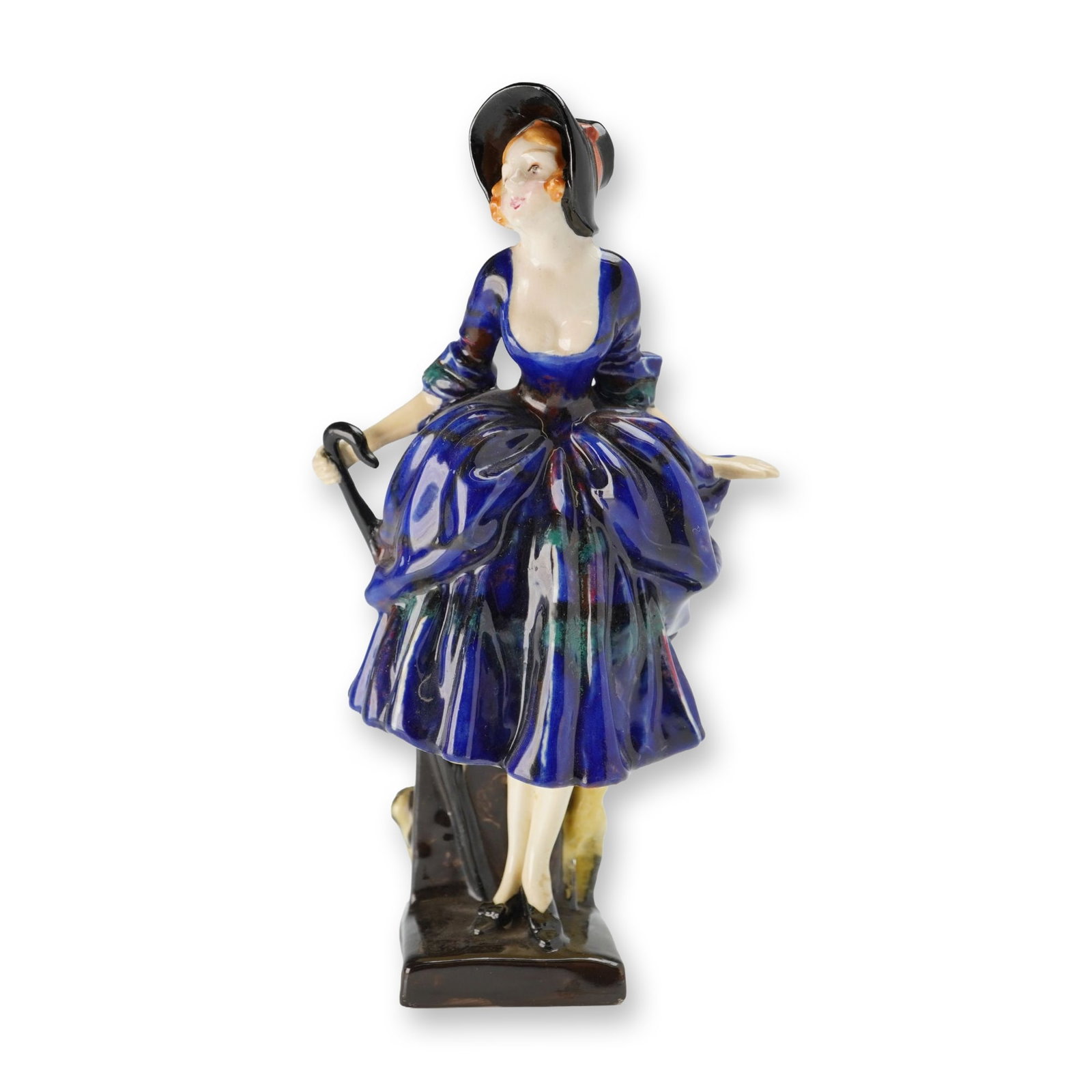 Royal Doulton Porcelain Figurine, Bo-Peep HN777: Designed by Leslie Harradine. The figure is depicted in 18th-century style costume, wearing a black wide-brimmed bonnet with a red ribbon and a deep cobalt blue dress with a tucked skirt over a floral
