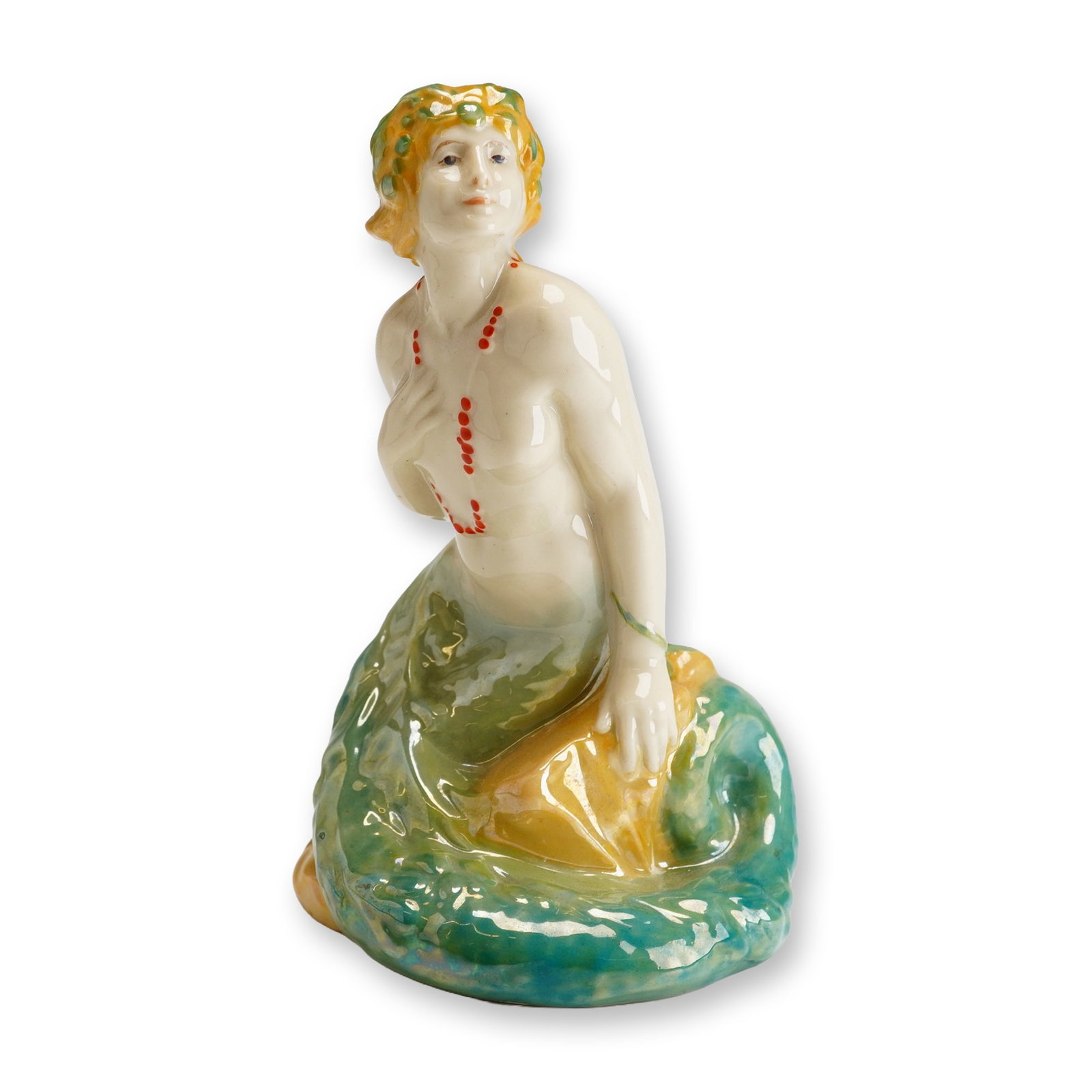 Royal Doulton Porcelain Lustre Figurine, Mermaid HN97: Part of the Royal Doulton Premiere Series, this figure was designed by Harry Tittensor and inspired by Hans Christian Andersen's classic tale, The Little Mermaid. It portrays a graceful mermaid with a