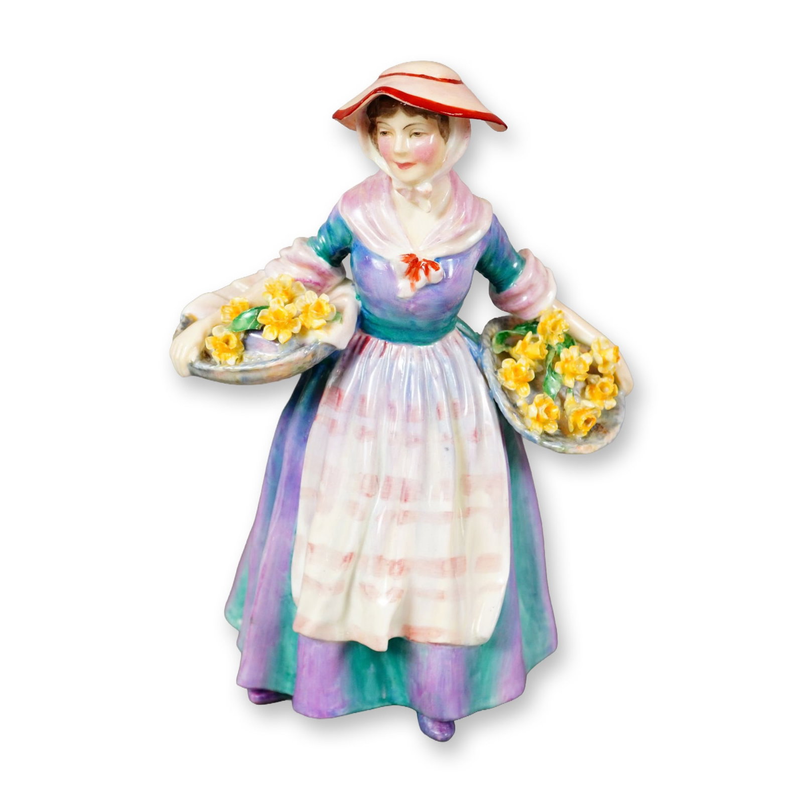 Royal Doulton Porcelain Figurine, Daffy Down Dilly HN1713: Part of the Harradine Classics series, designed by Leslie Harradine. Hand-painted figure depicting a woman in a purple and blue dress with an apron, holding two baskets filled with yellow daffodils. F