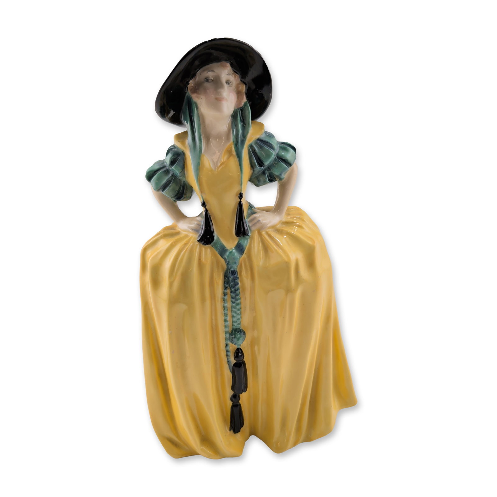 Royal Doulton Porcelain Figurine, Patricia HN1414: Polychrome glazed porcelain depicting a woman in period dress featuring a yellow gown, puffed green sleeves, and a wide-brimmed black hat, holding an ornamental chain with black tassels. The underside