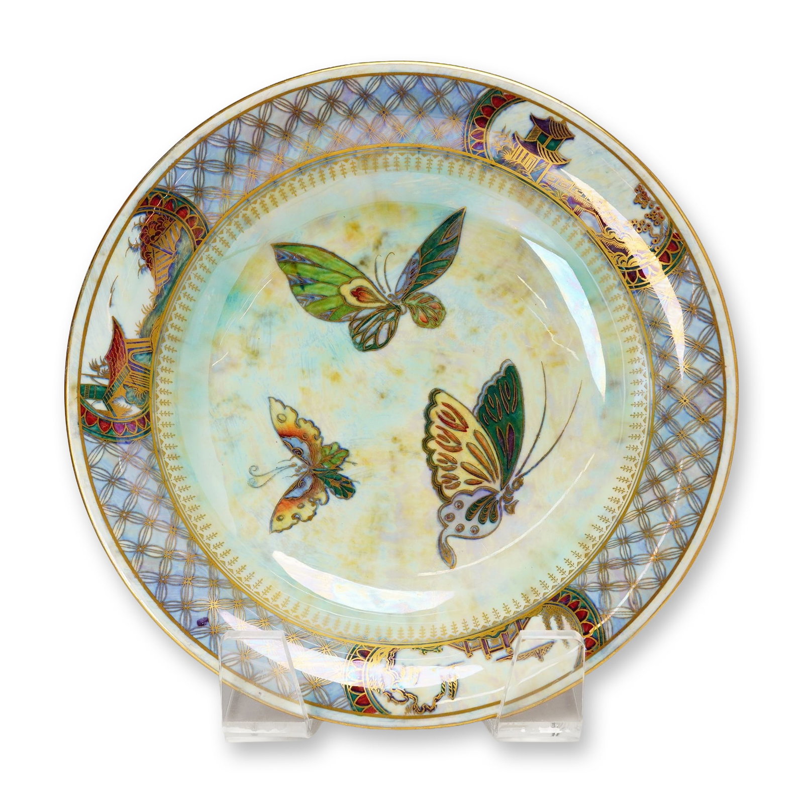 Wedgwood Fairyland Lustre Lily Tray, Butterflies Z4827: Designed by Daisy Makeig-Jones, this piece features an exterior finished in ruby lustre with subtle staining and blue mottling, and is adorned with gilt butterflies. The interior is finished in a moth
