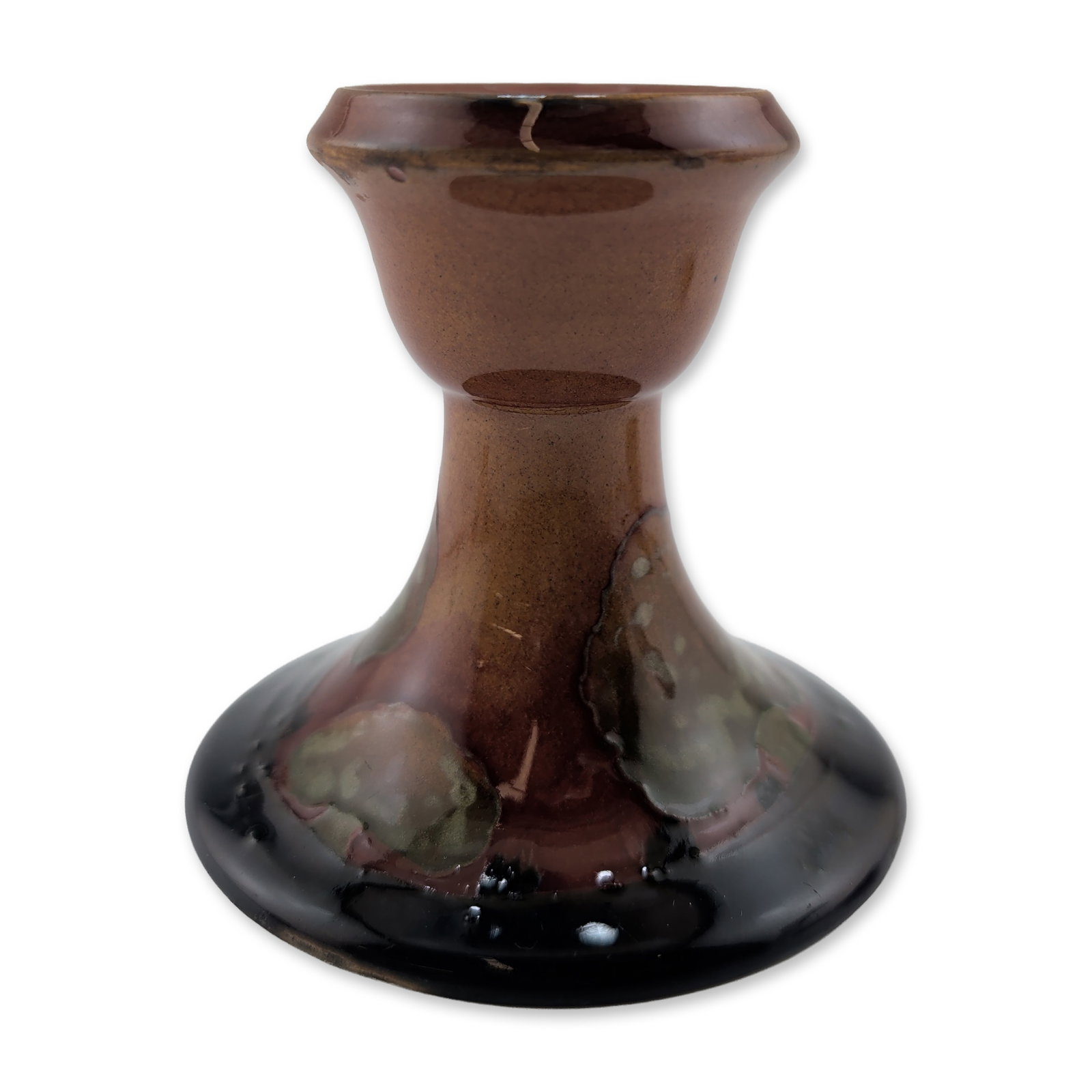 Moorcroft Pottery Candlestick, Eventide: The form includes a flared rim and tapered neck in a reddish-brown glaze, transitioning into a multi-toned base with hues of oxblood, ochre, and dark forest landscape. The underside is impressed with 