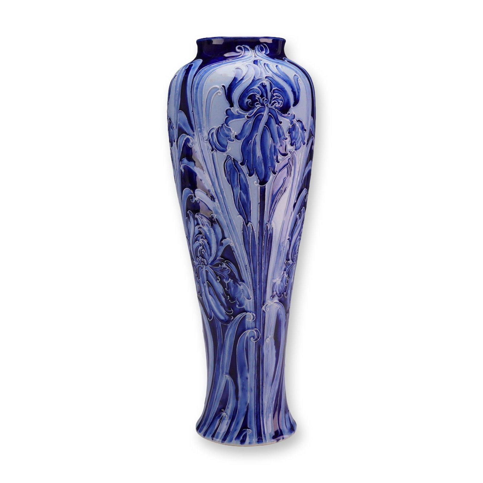 William Moorcroft for James Macintyre and Co. Florian Ware Vase, Iris: The slender, waisted form features a bulbous shoulder and a slightly flared foot and rim. The piece is decorated in the Iris pattern, executed using a tube-lining technique to create raised outlines o