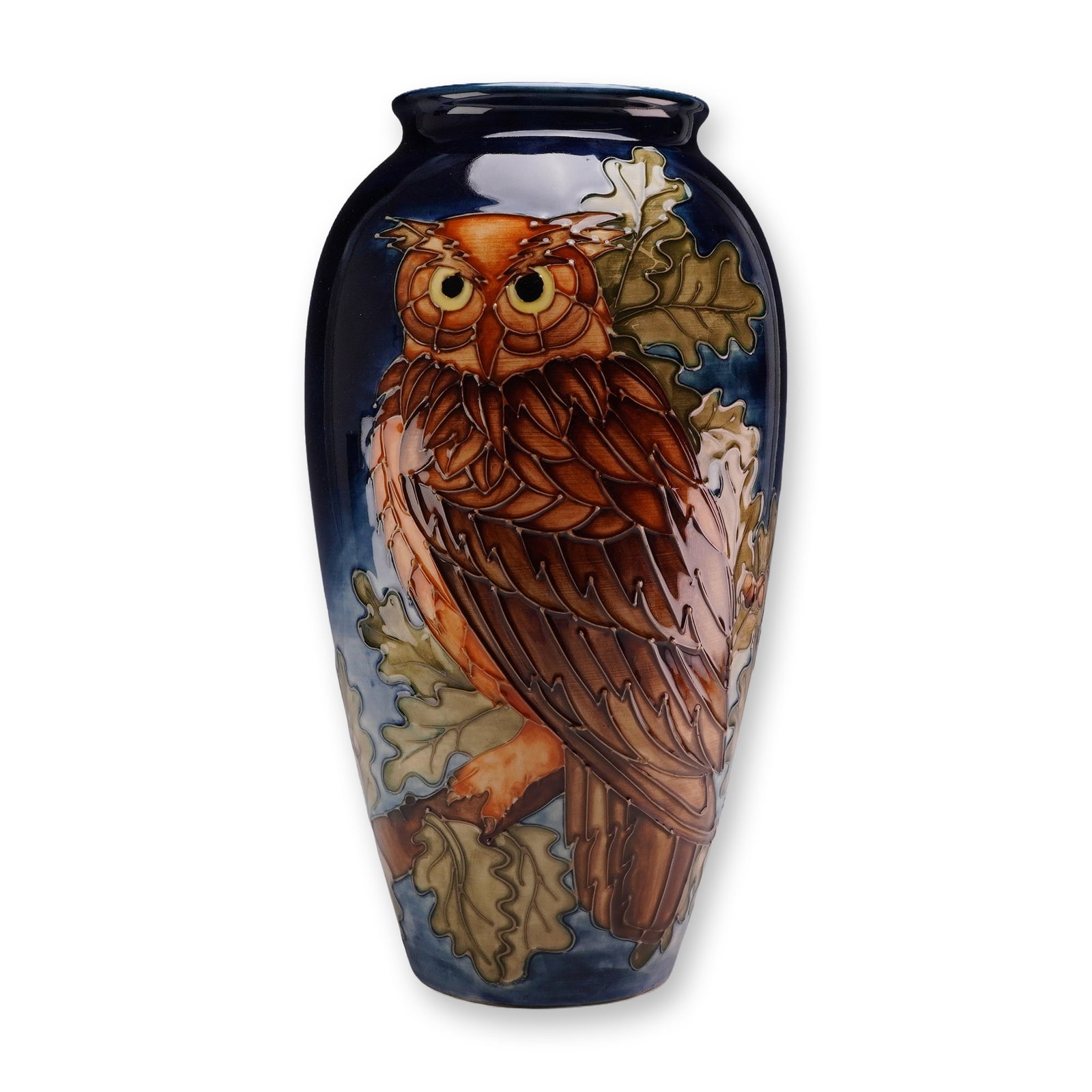 Moorcroft Pottery by Sally Tuffin Limited Edition Vase, Eagle Owl: The vase has an ovoid form with a slightly flared neck and a tapering foot. The exterior is decorated with tubelined outlines and hand-painted glazes, depicting a large owl with yellow eyes perched on