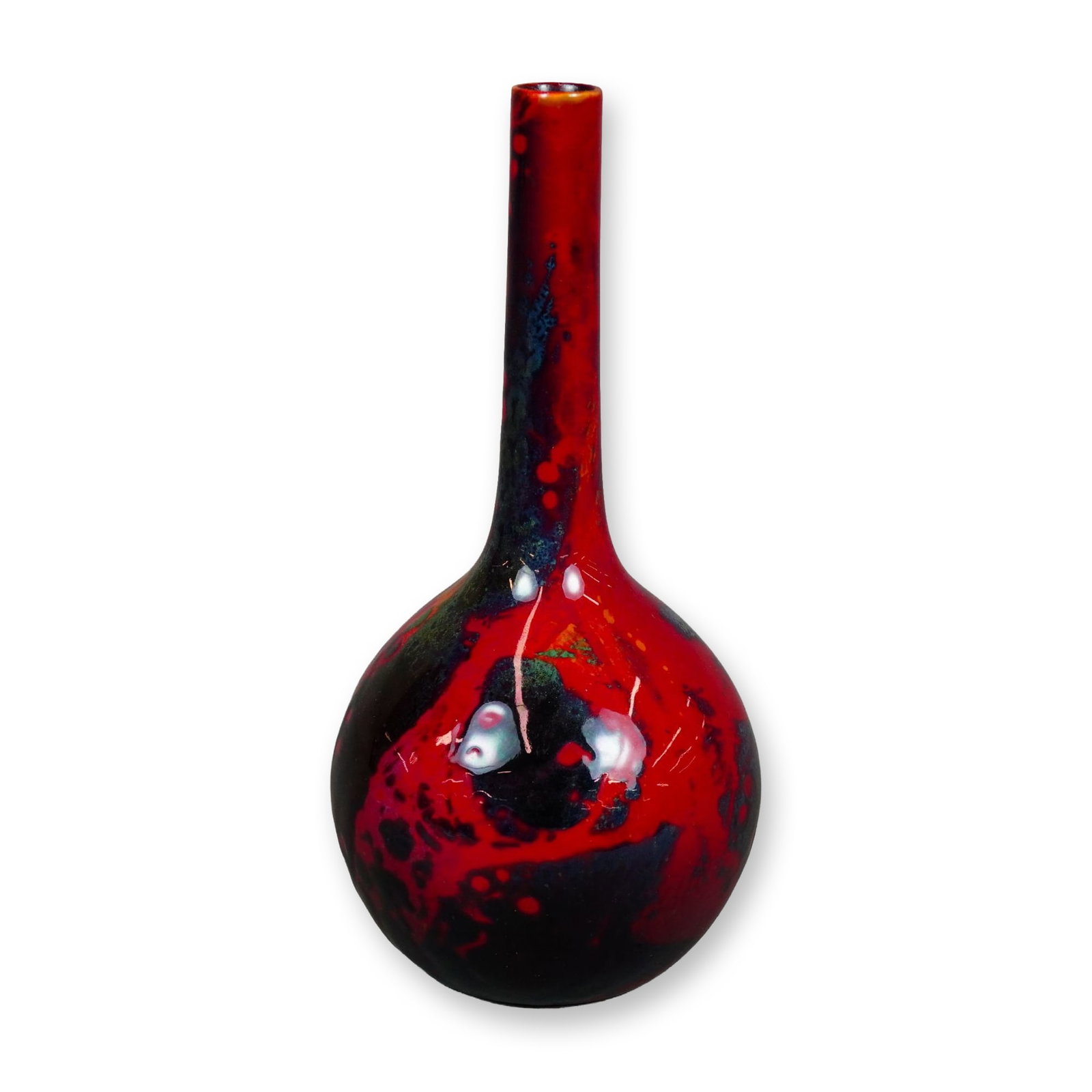Royal Doulton Flambe Sung Vase: A hand-decorated bottle-shaped vase featuring a rounded, bulbous body and a long, slender neck. Finished in a red flambe glaze with mottled accents of blue and yellow throughout. The base is marked Ro