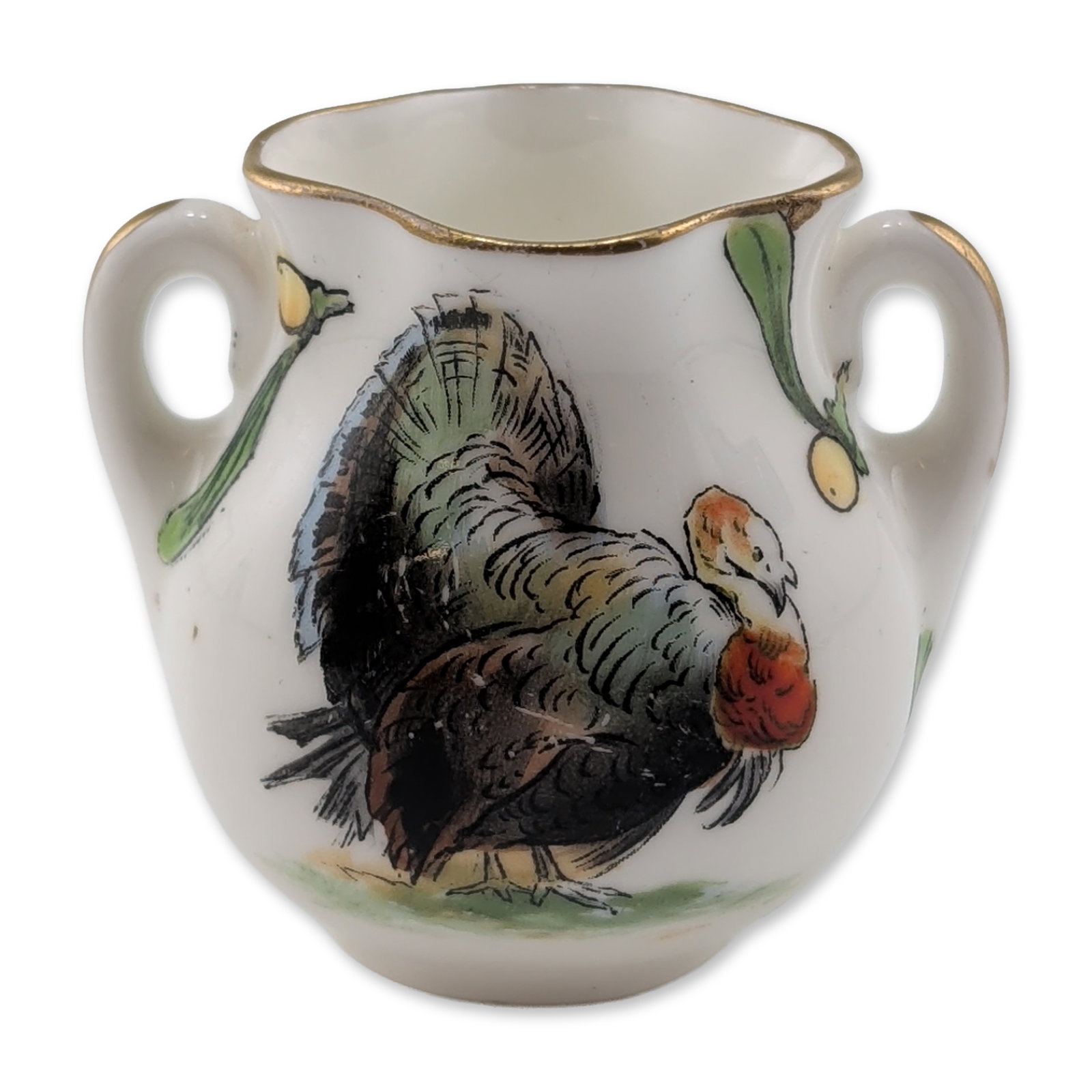 Royal Doulton Miniature Turkey Loving Cup: Featuring transfer-printed and hand-colored holiday motifs. The bulbous body is decorated with a turkey on one side and a holly sprig with berries on the reverse, accented with mistletoe sprigs near t